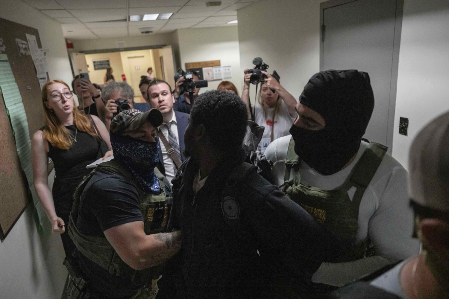A person is detained by federal agents outside an immigration court at the Jacob K. Javits federal ...