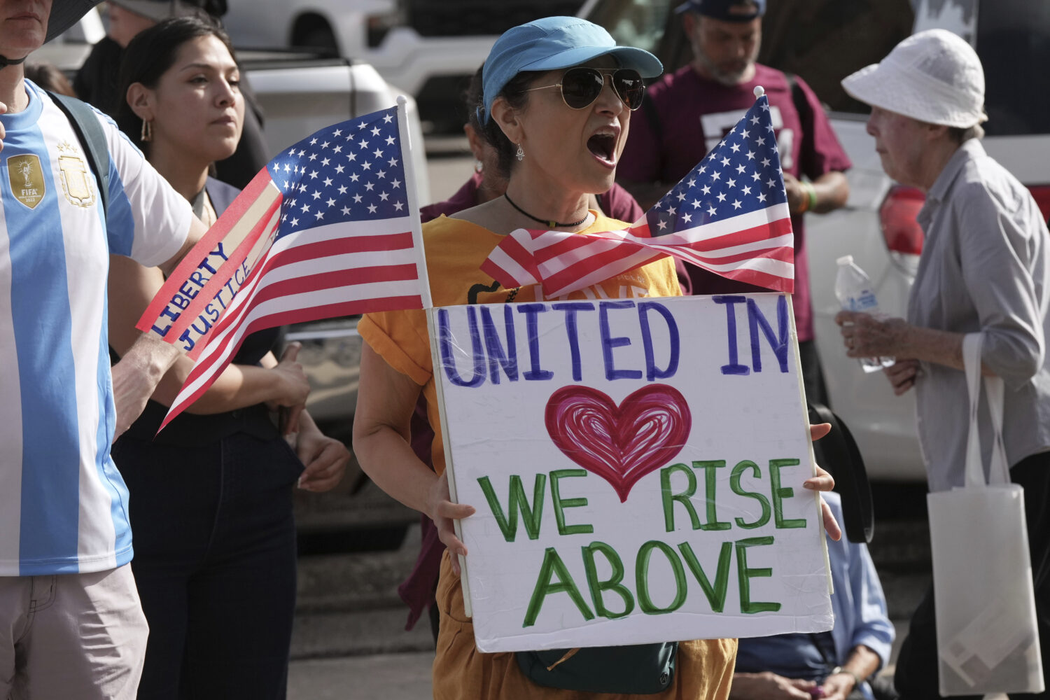Immigration advocates protest recent detentions by ICE outside the immigration court in San Antonio...