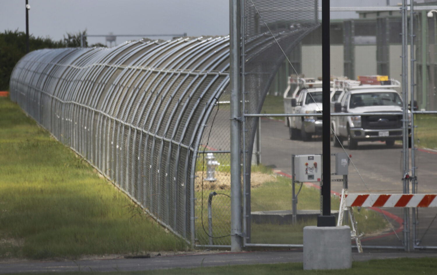 FILE - Trucks drive at the Prairieland Detention Center in Alvarado, Texas, Sept. 15, 2016. (Louis ...