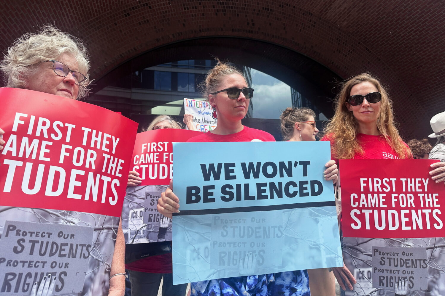 People show their support for a lawsuit challenging the Trump administration's policy of targeting ...