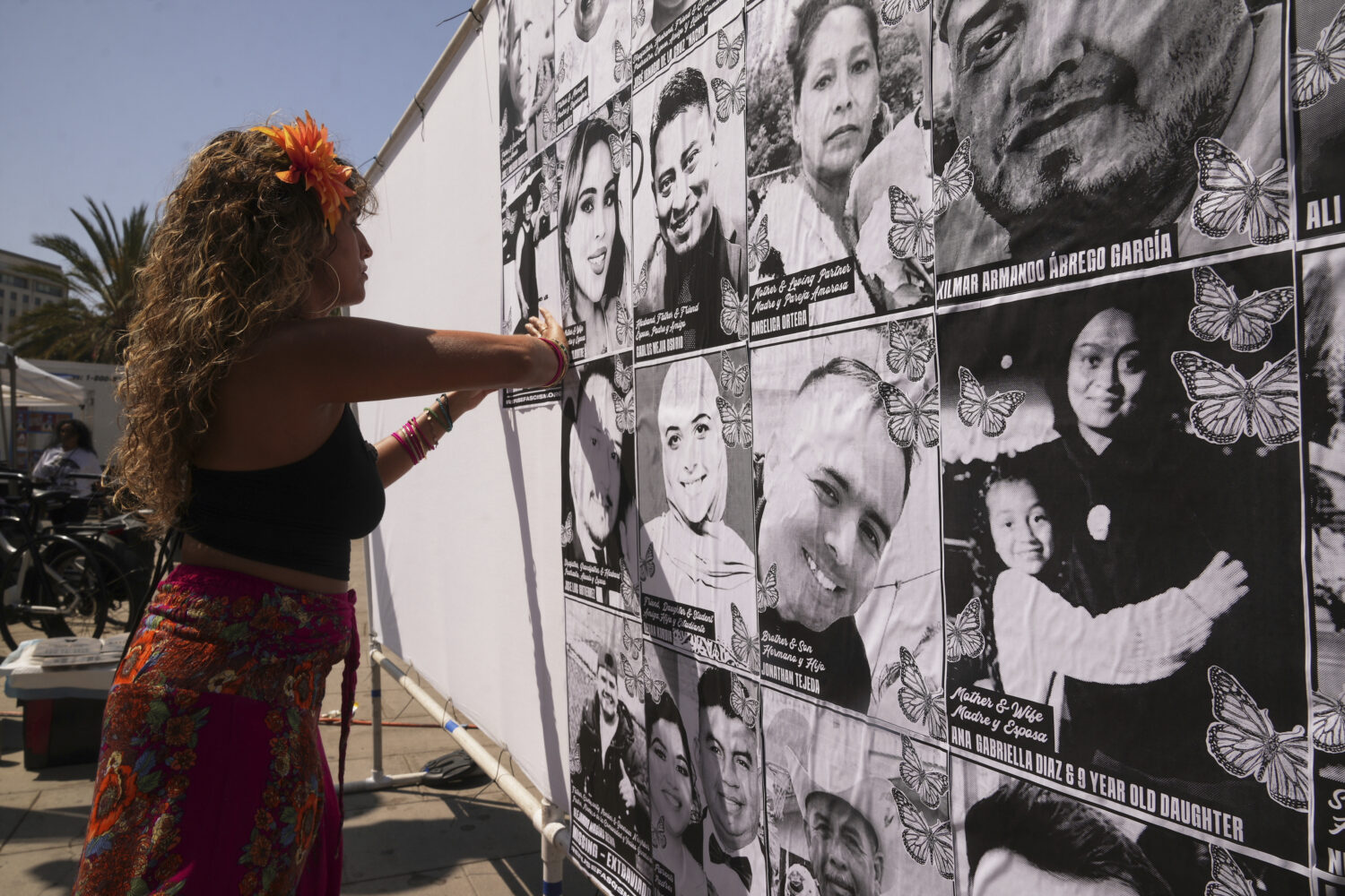 Special needs teacher Deja Nebula sets up an art installation displaying names and faces of people ...