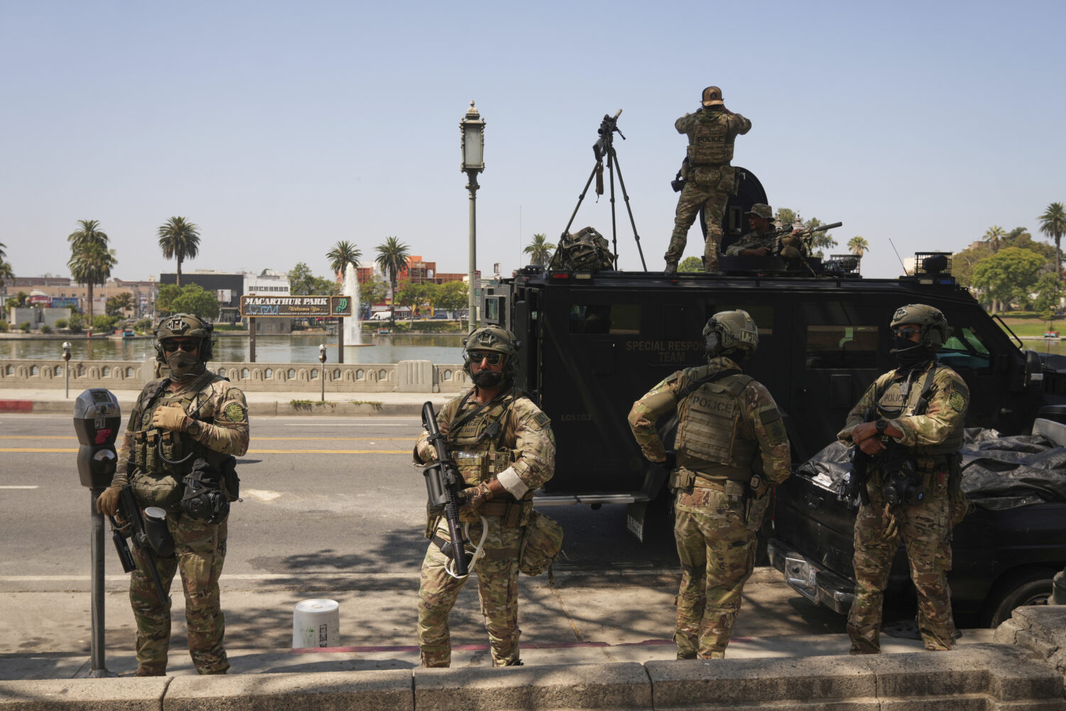 Federal agents stage at MacArthur Park Monday, July 7, 2025, in Los Angeles. (AP Photo/Damian Dovar...