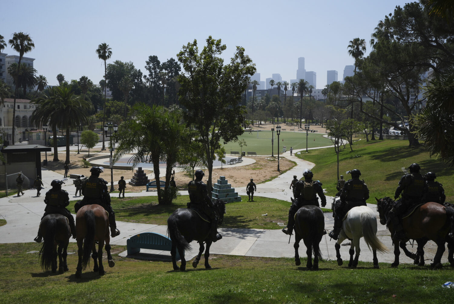 FILE - Federal agents ride on horseback at MacArthur Park Monday, July 7, 2025, in Los Angeles. (AP...