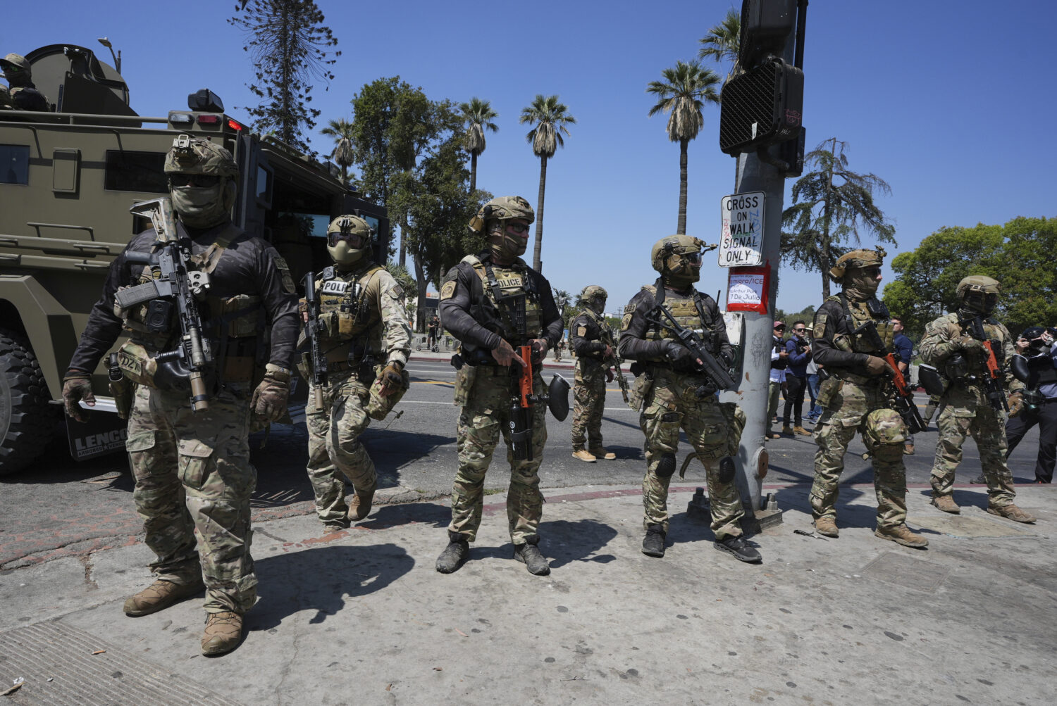 FILE - Federal agents stage at MacArthur Park Monday, July 7, 2025, in Los Angeles. (AP Photo/Damia...