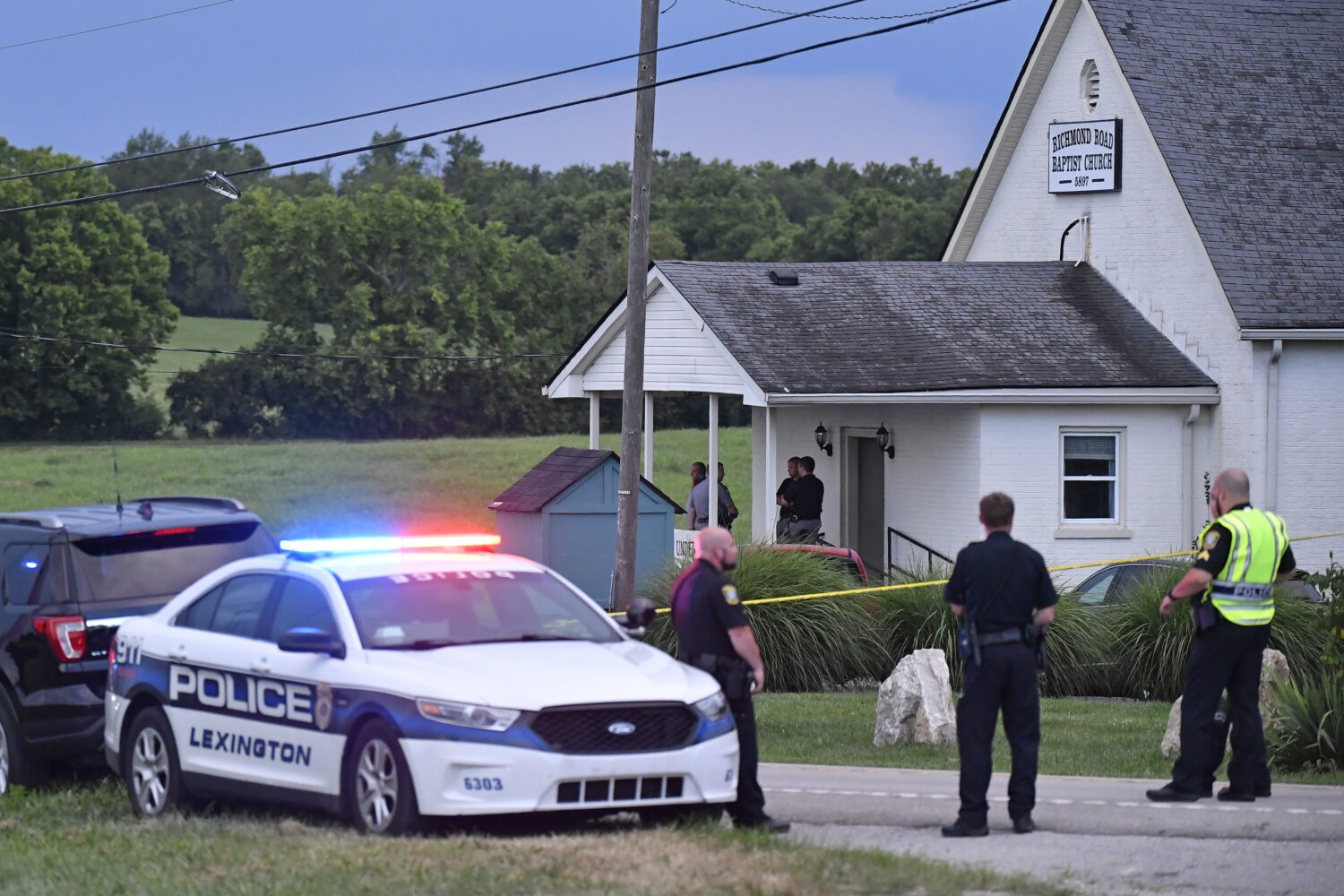 Police stand at the front of the Richmond Road Baptist Church as other officers maintain a perimete...