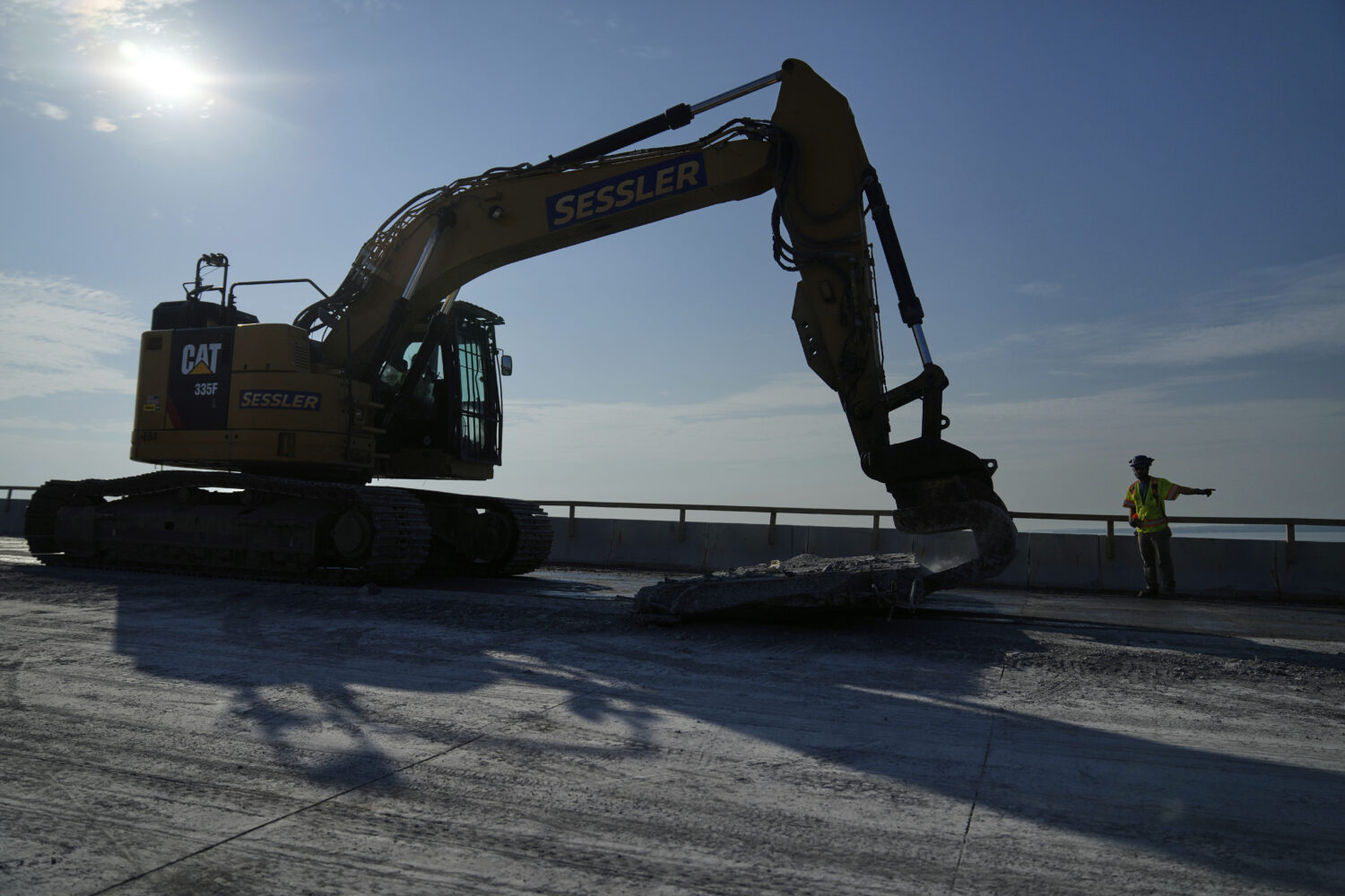 A demolition crew removes a slab of concrete from the remaining portions of the Francis Scott Key B...