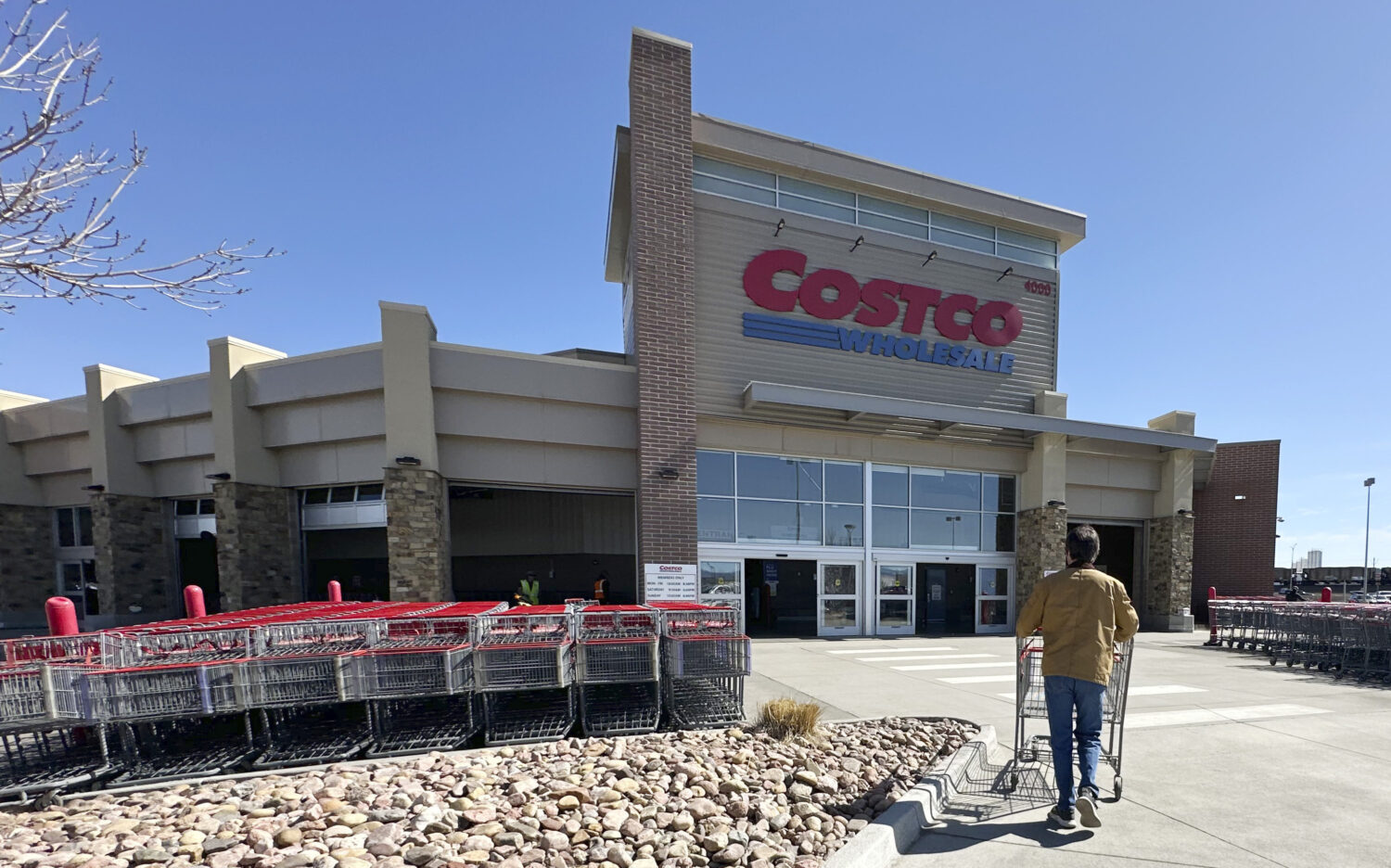 FILE - A lone shopper pushes a cart toward the entrance of a Costco warehouse, March 13, 2025, in S...