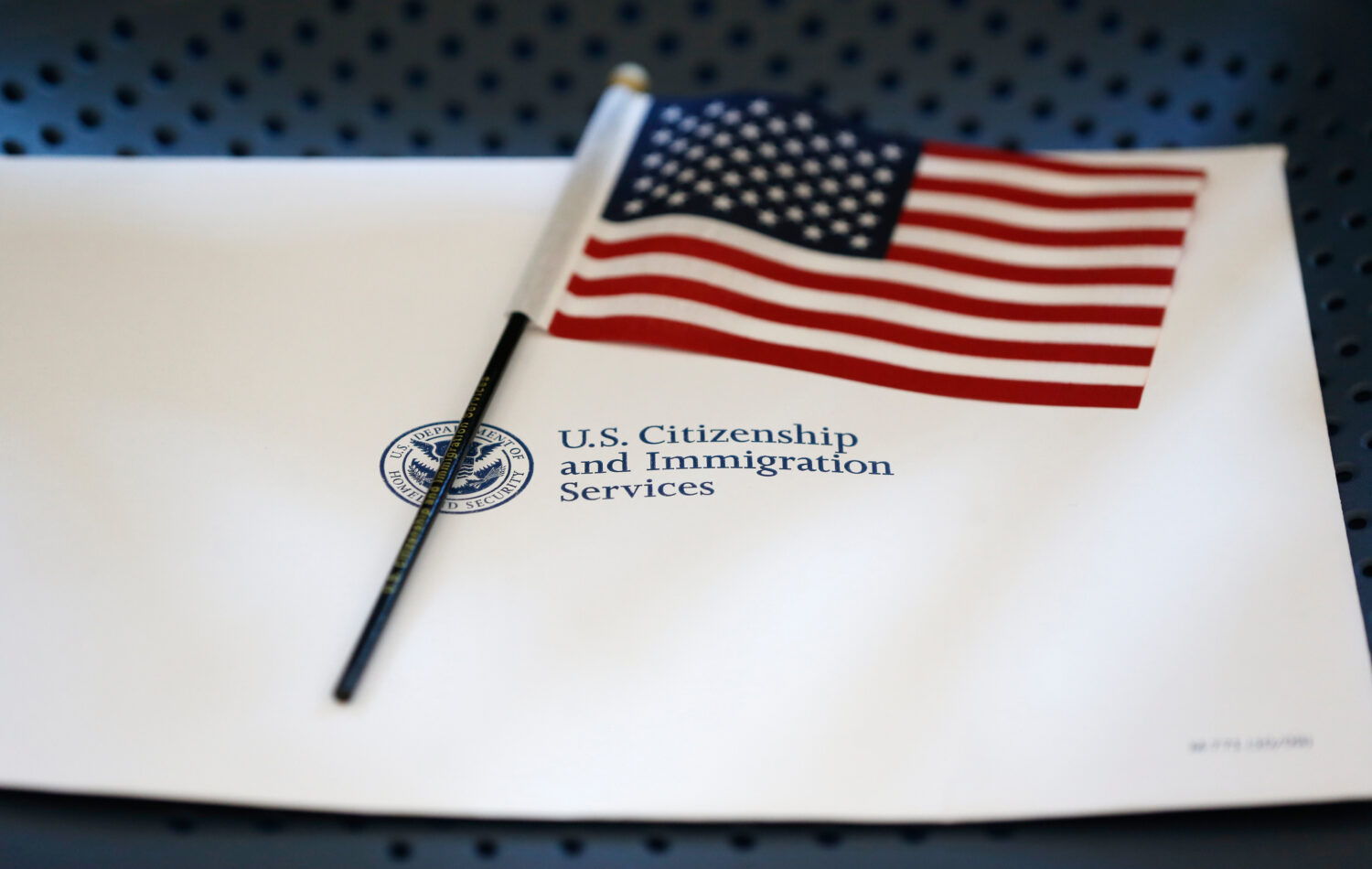 FILE - An information packet and an American flag are placed on a chair at the U.S. Citizenship and...