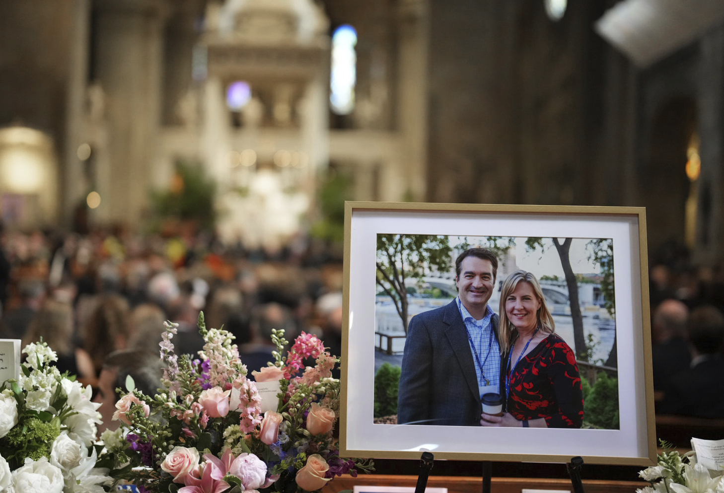 Pictures of Mark and Melissa Hortman are set up inside the sanctuary at the Basilica of St. Mary's ...