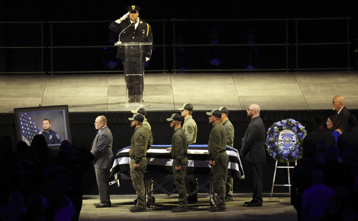 The casket of Lorain police Officer Phillip Wagner is moved by fellow SWAT members during the memor...