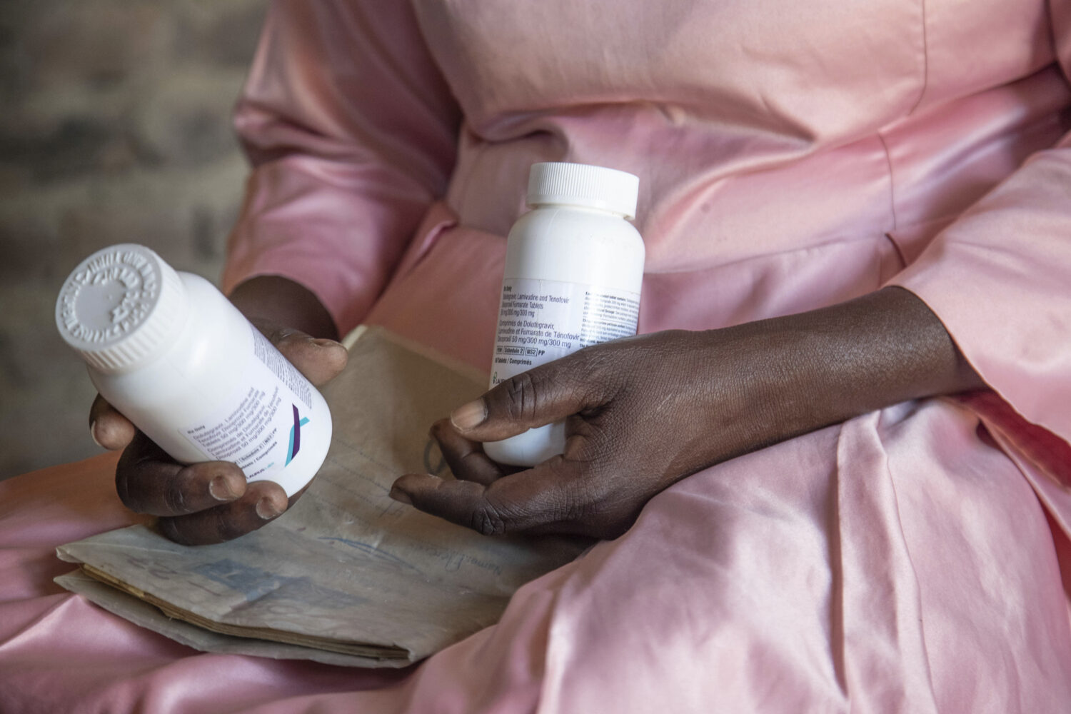FILE - Florence Makumene holds HIV medication that she received through funding from the U.S. Presi...
