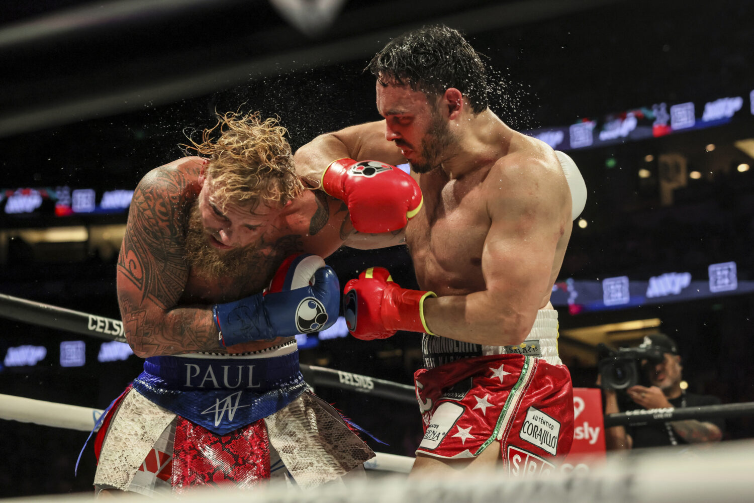 Julio Cesar Chavez Jr., right, punches Jake Paul during their cruiserweight boxing match on Saturda...