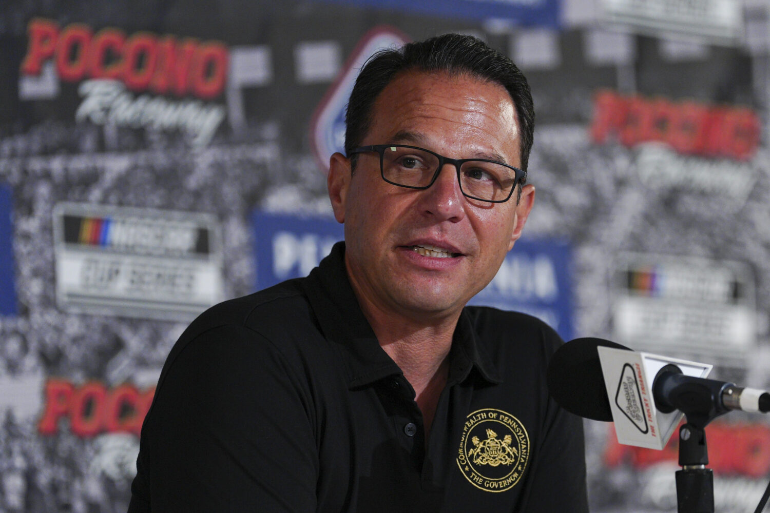 FILE - Pennsylvania Gov. Josh Shapiro talks to the media prior to a NASCAR Cup Series auto race at ...