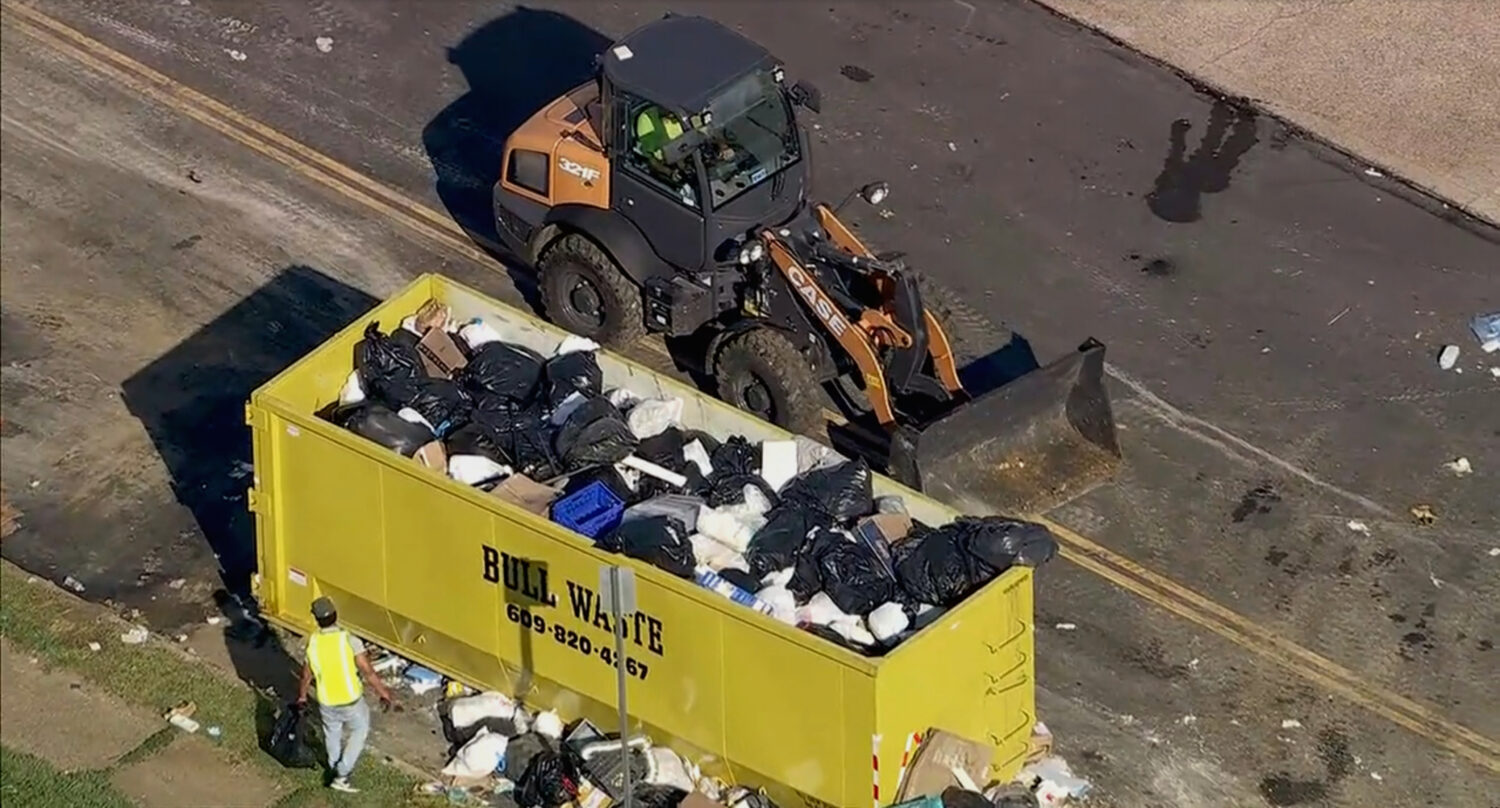 Trash is cleaned up at a drop-off site in Philadelphia as thousands of city workers remained on str...