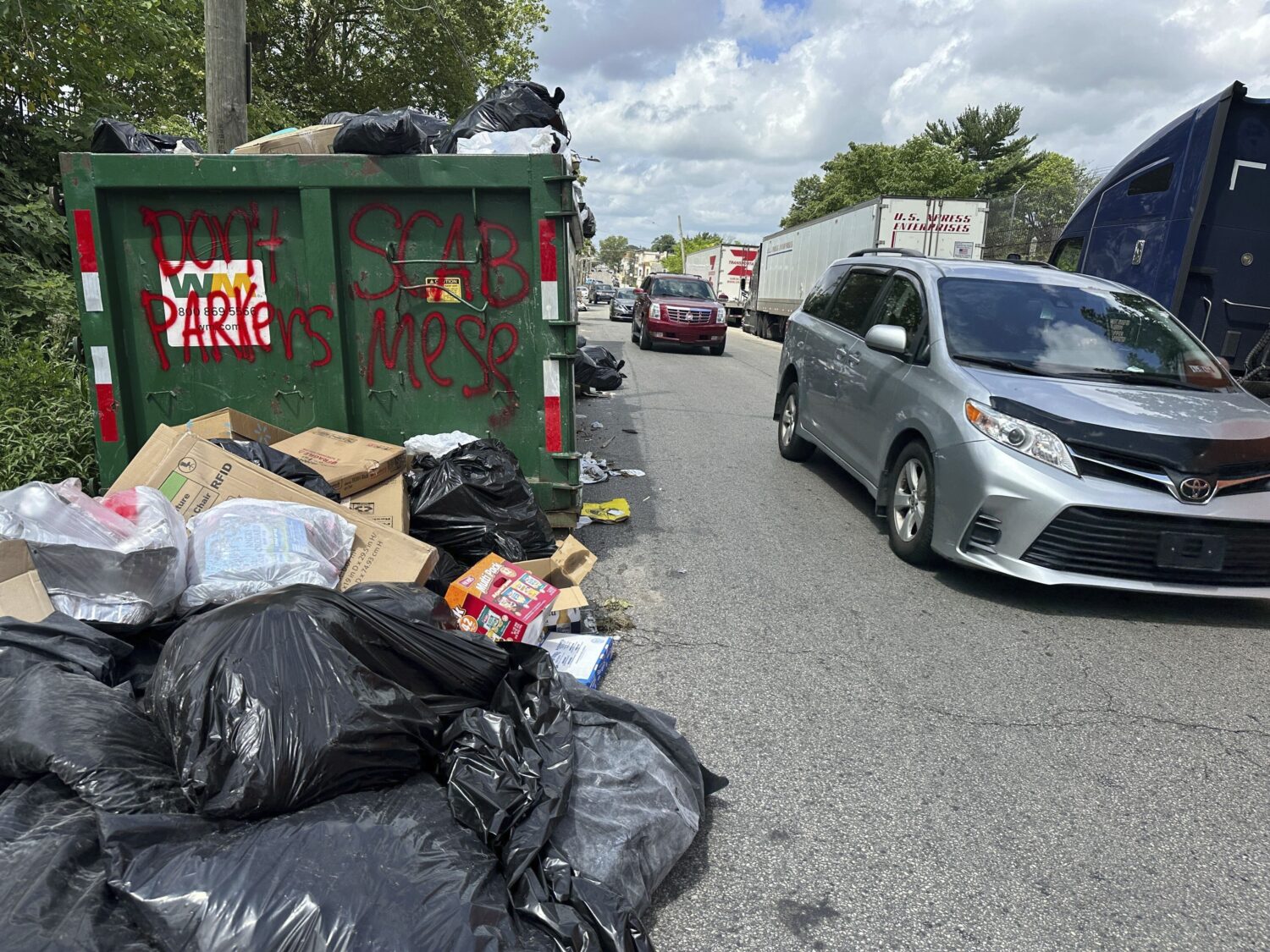 Trash piles up around dumpsters in Philadelphia as thousands of city workers remained on strike Mon...