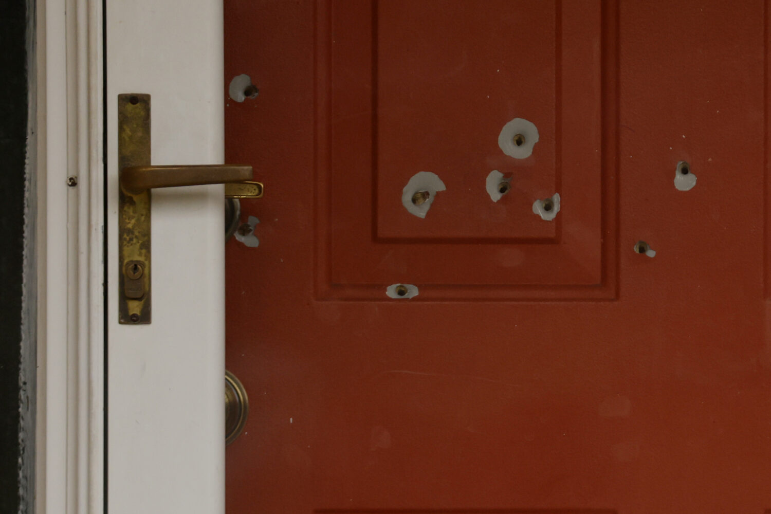 Bullet holes mark the front door of the house of Minnesota state Sen. John Hoffman and his wife who...