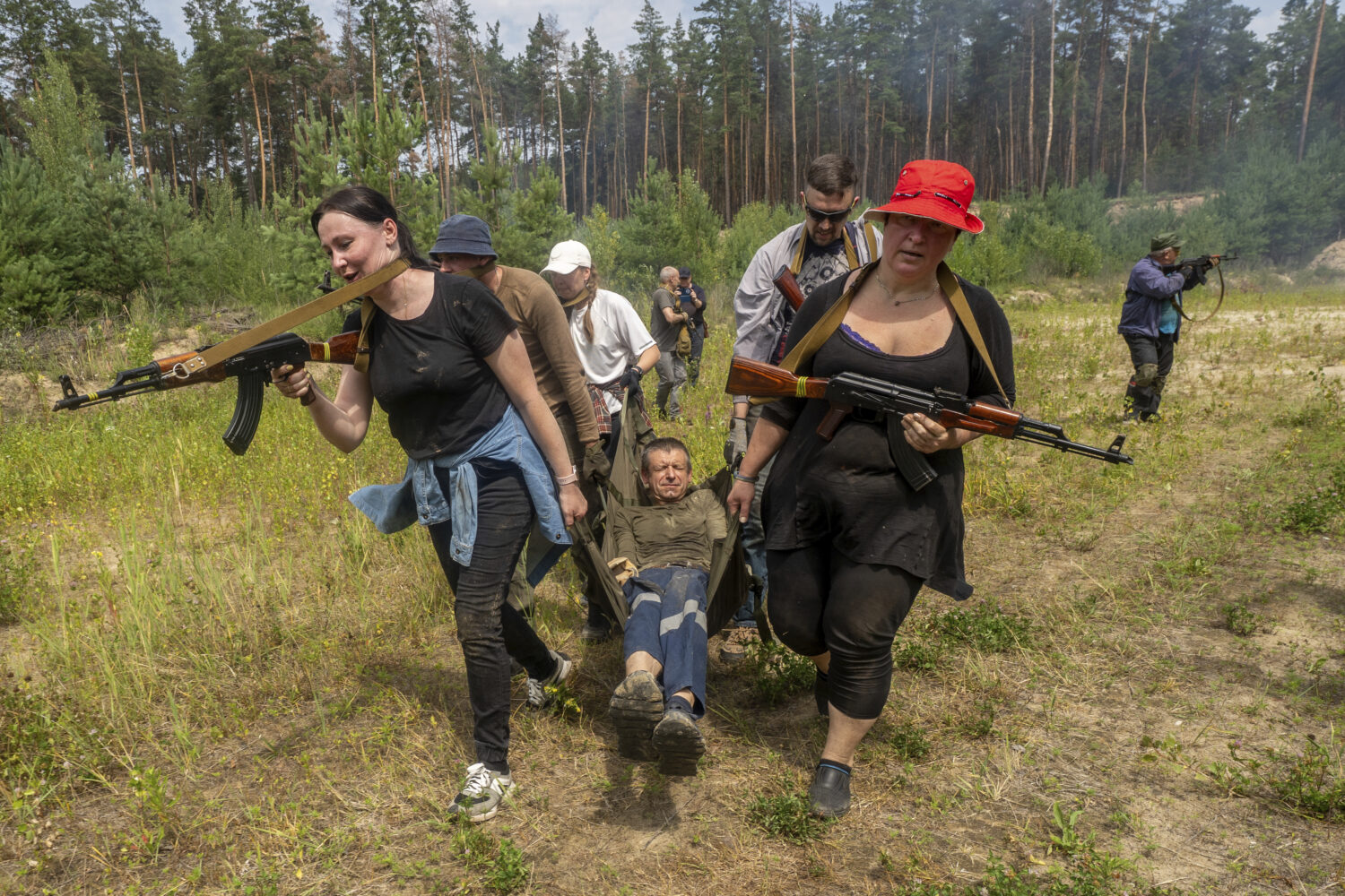 Civilians practice military skills on a training ground in Kharkiv, Ukraine, Saturday, July 12, 202...