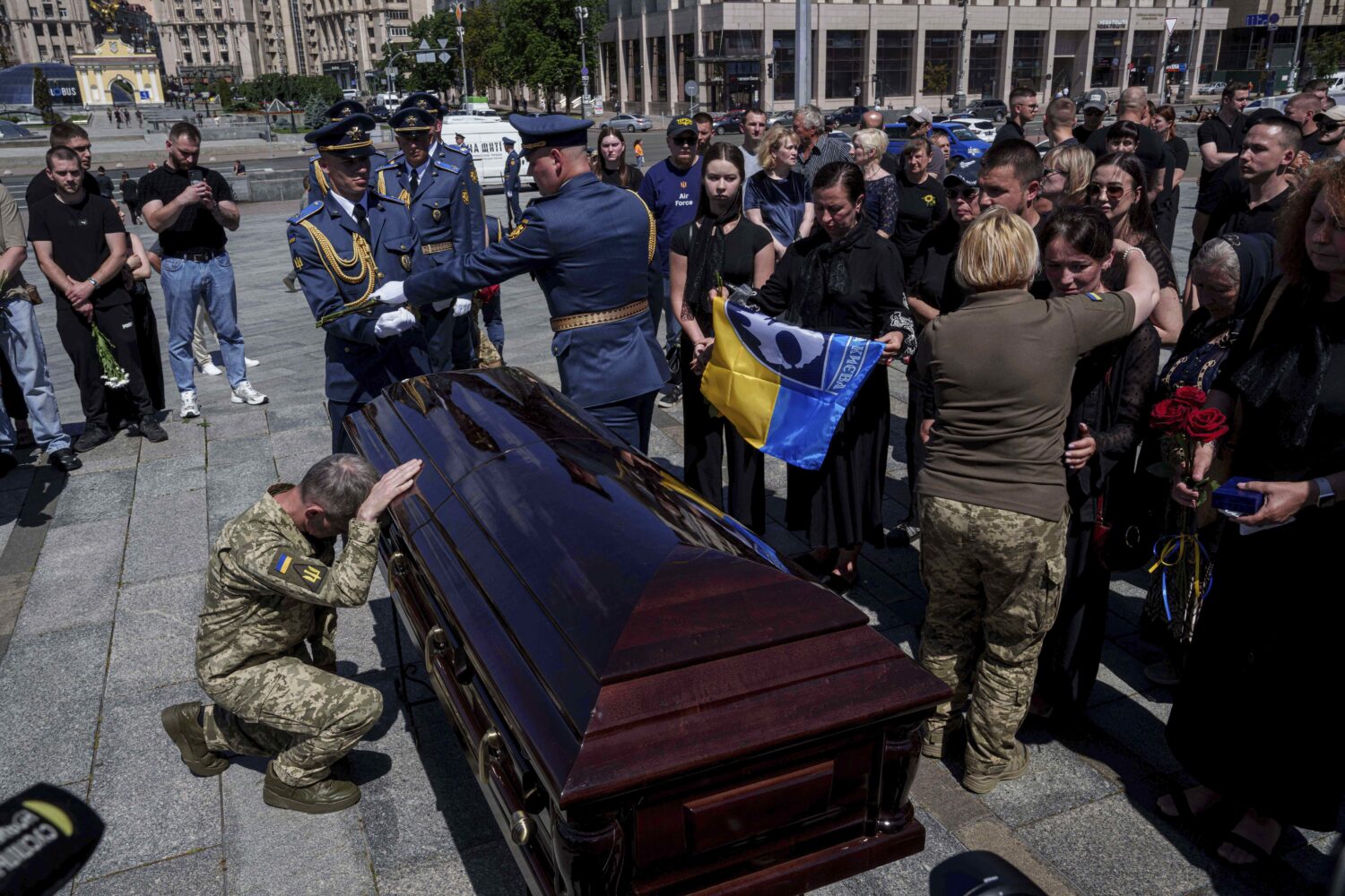 A Ukrainian serviceman says goodbye to Ukrainian F-16 pilot Maksym Ustymenko, during a farewell cer...