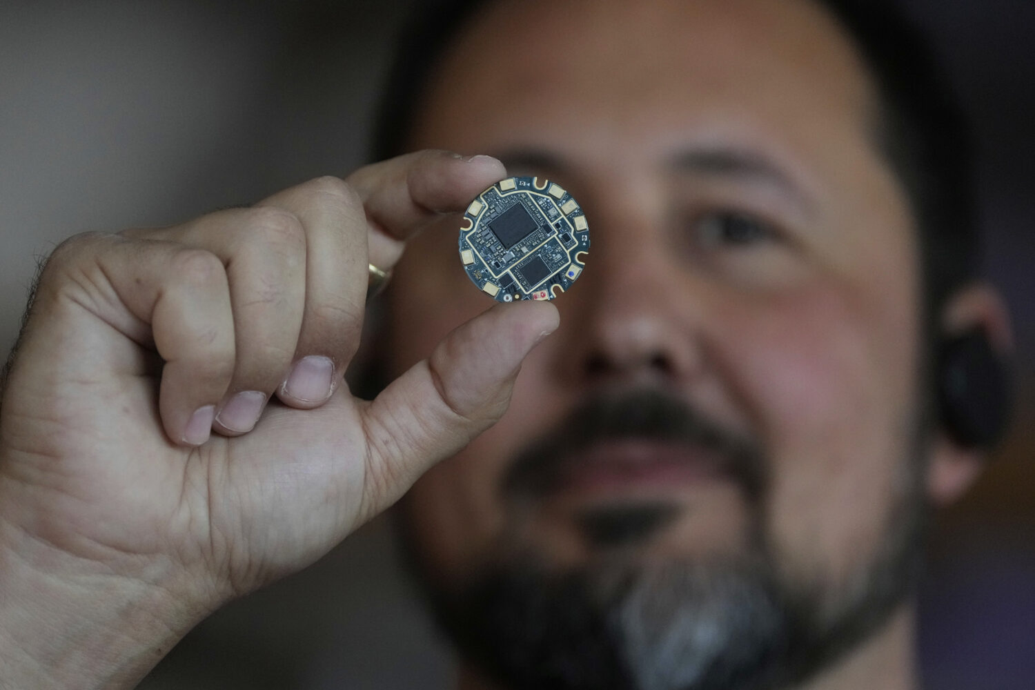 FILE - Jason Rugolo, founder and CEO of iyO, shows the motherboard of the iyO One audio computer wh...