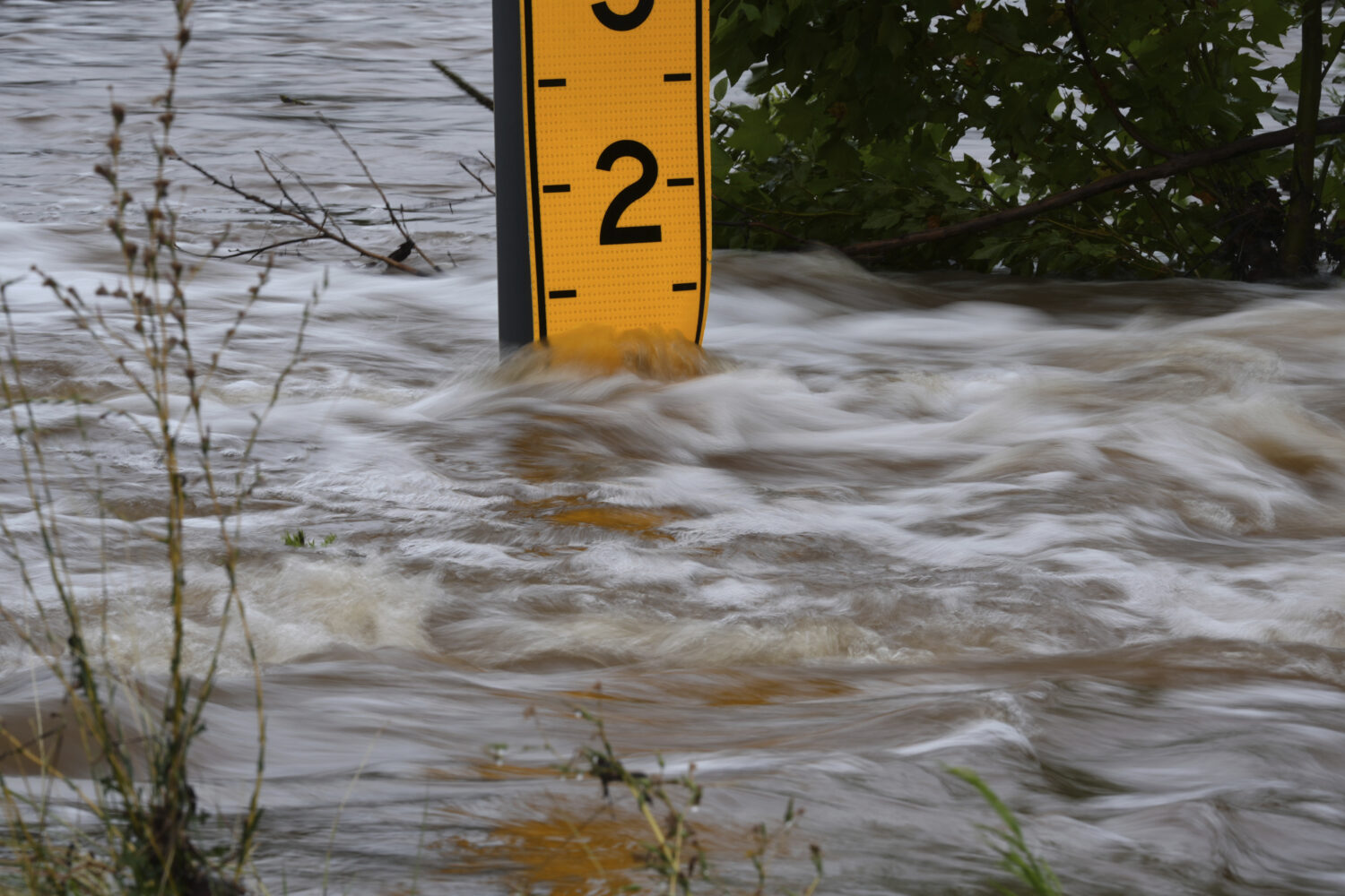 A flood gauge marks the height of water flowing over a farm-to-market road near Kerrville, Texas, o...