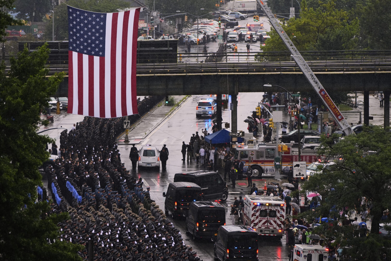 The hearse carrying the casket of NYPD officer Didarul Islam is escorted down White Plains road aft...