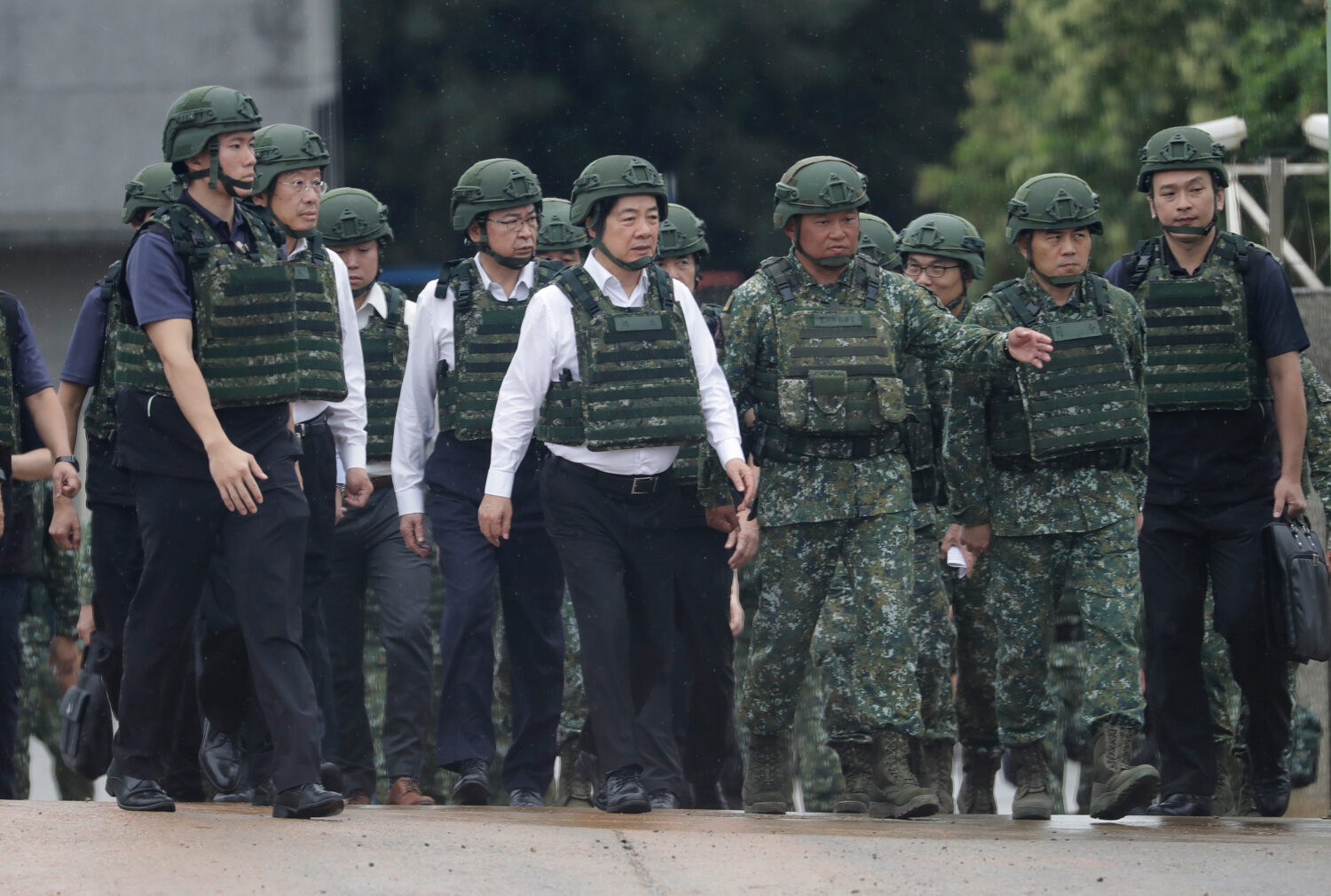Taiwan President Lai Ching-te, center, inspects a live-fire shooting training in Hsinchu County, Ta...