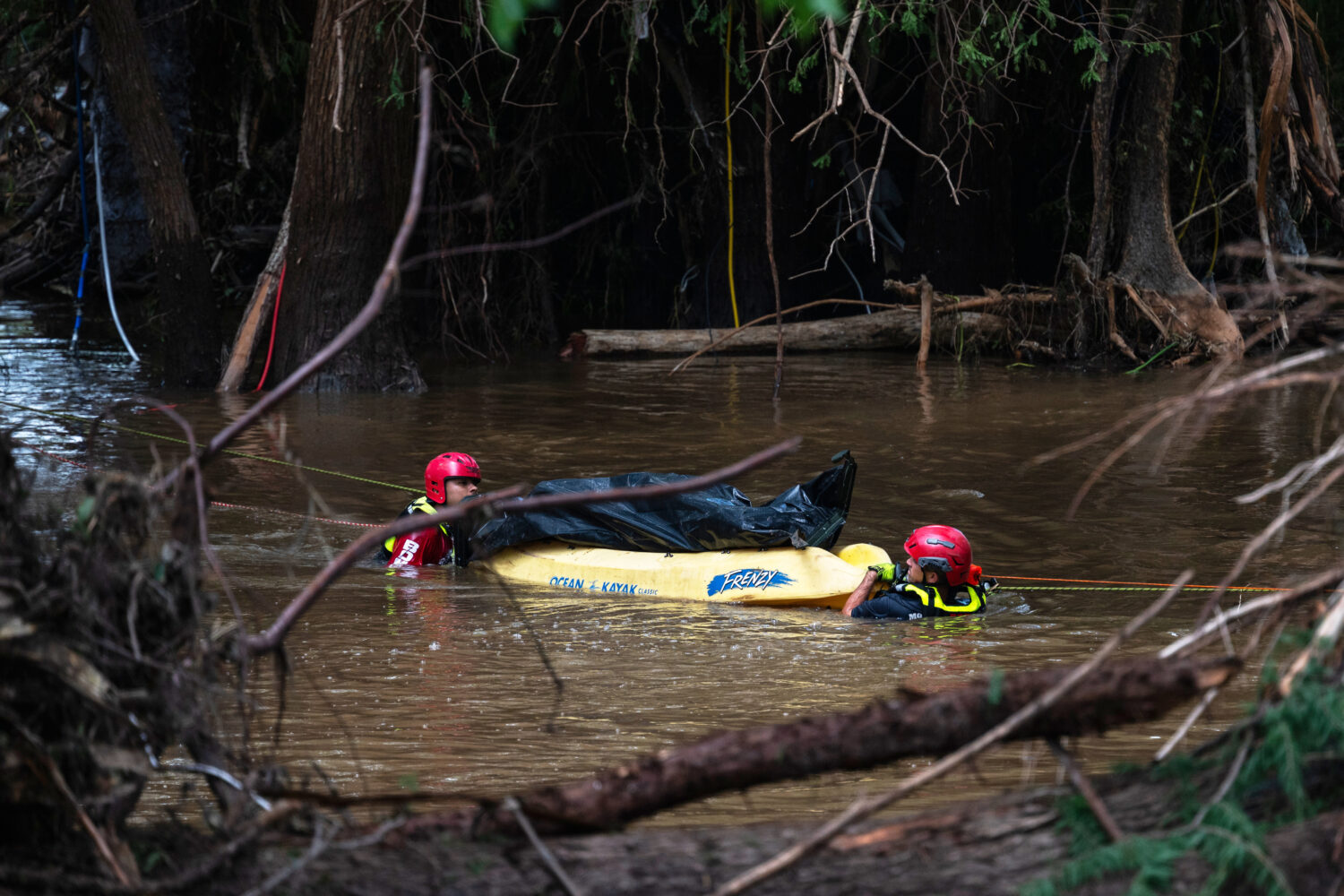 Firefighters from Ciudad Acuña, Mexico, perform a water recovery of a body in a portion of the flo...