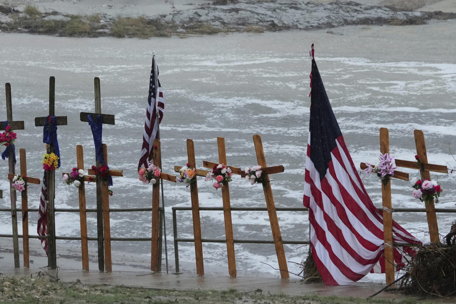FILE - Rain falls over a makeshift memorial for flood victims along the Guadalupe River, Sunday, Ju...