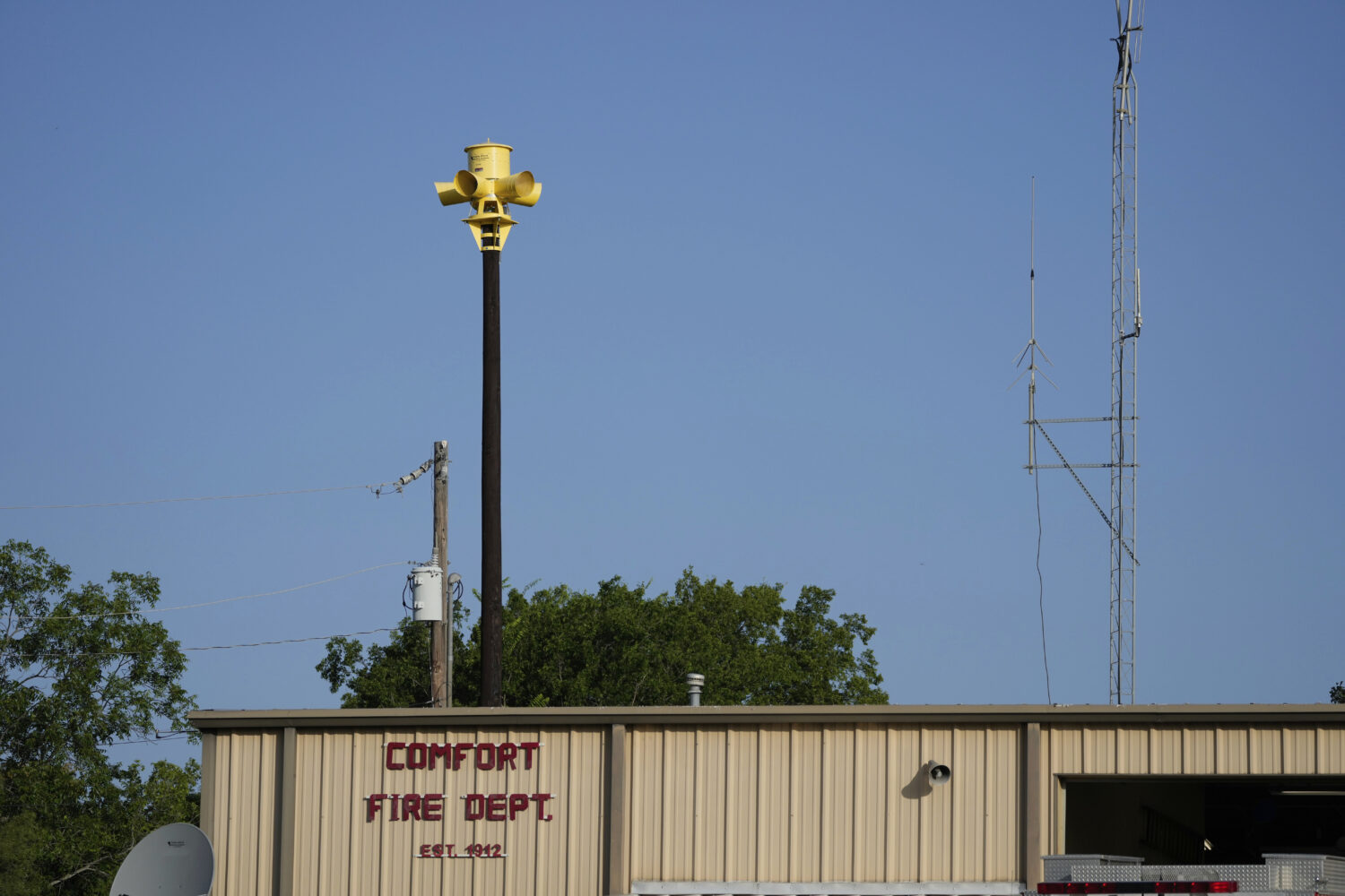 An emergency siren is visible on top of the Comfort Volunteer Fire Department in Comfort, Texas on ...