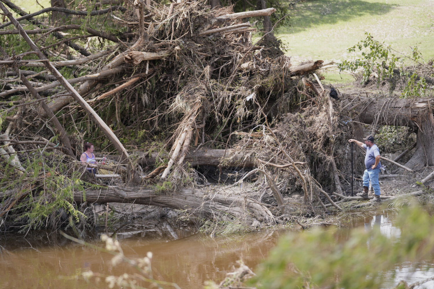 People search along the Guadalupe River after flooding in Kerrville, Texas on Wednesday , July 9, 2...