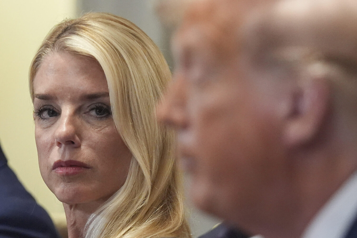 Attorney General Pam Bondi, left, listens as President Donald Trump, right, speaks during a cabinet...
