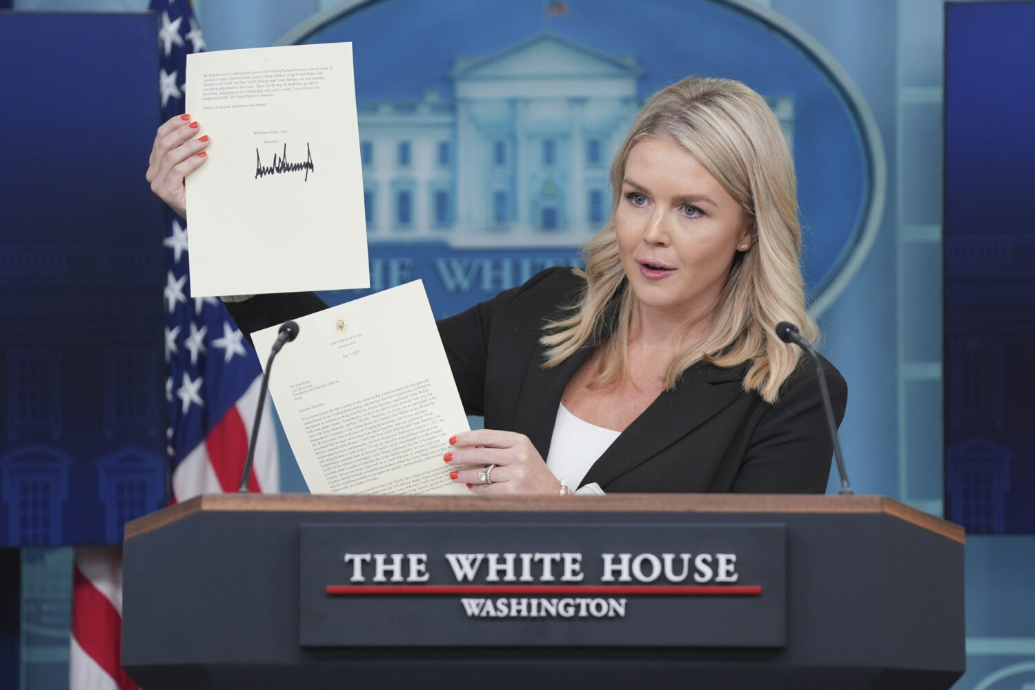 White House press secretary Karoline Leavitt speaks as she holds up a letter from President Donald ...