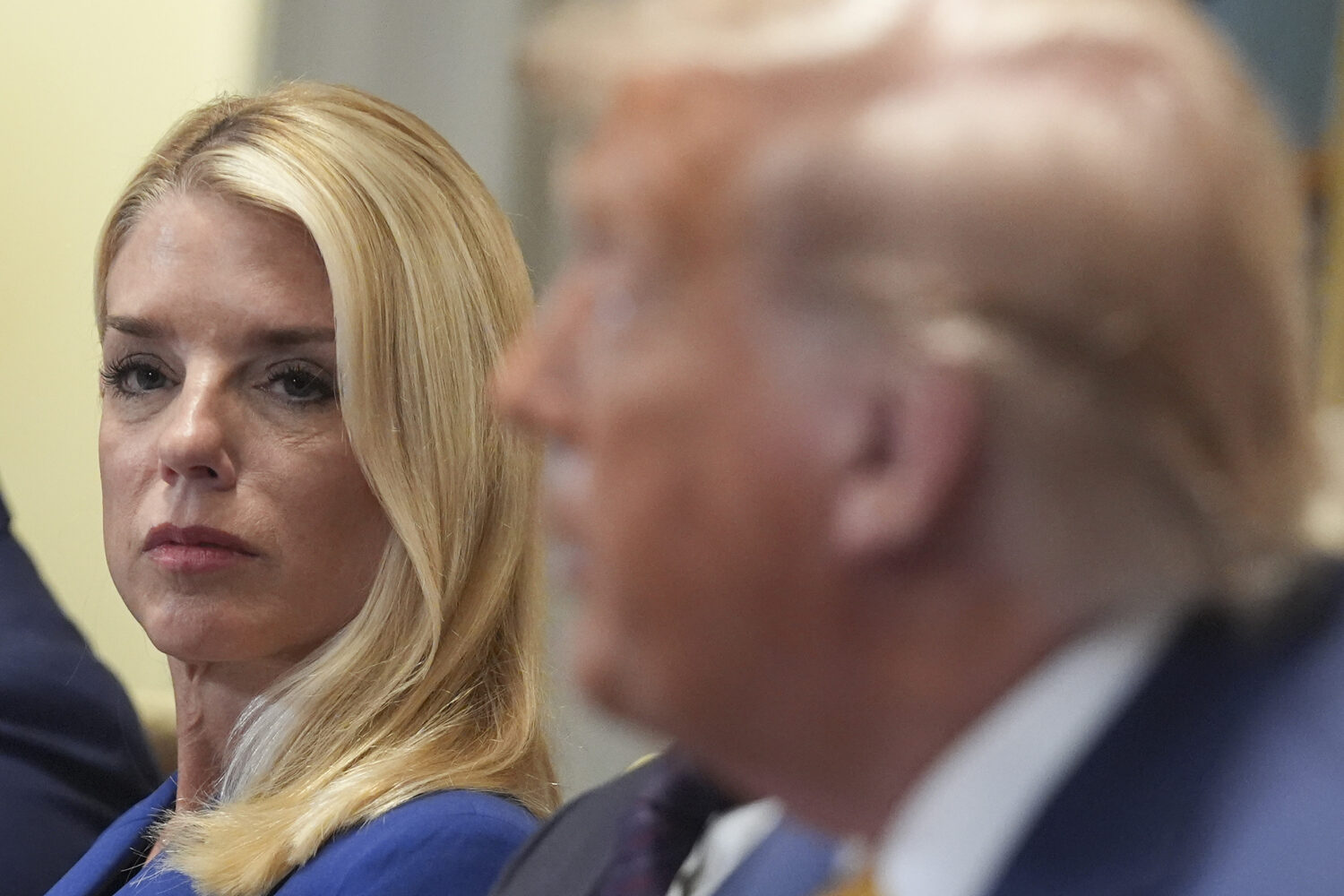 Attorney General Pam Bondi, left, listens as President Donald Trump, right, speaks during a cabinet...