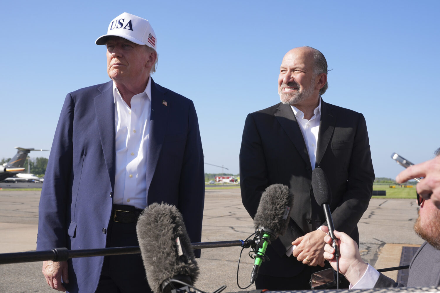 President Donald Trump, left, listens as Commerce Secretary Howard Lutnick speaks with reporters be...