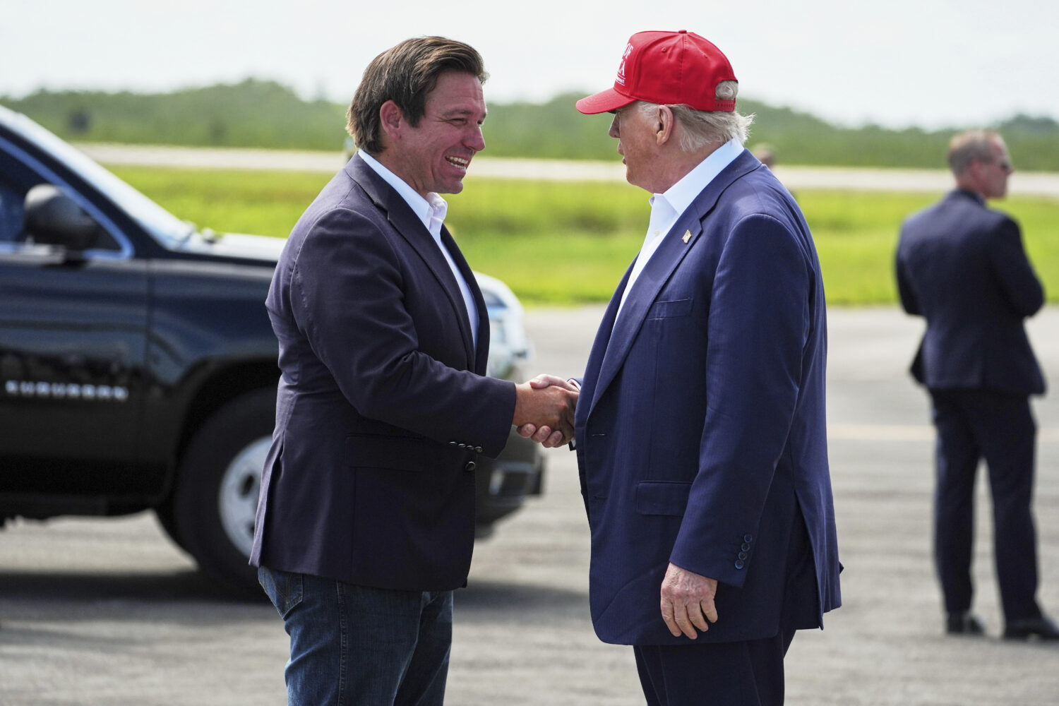 President Donald Trump is greeted by Gov. Ron DeSantis, R-Fla., as he arrives at "Alligator Alcatra...
