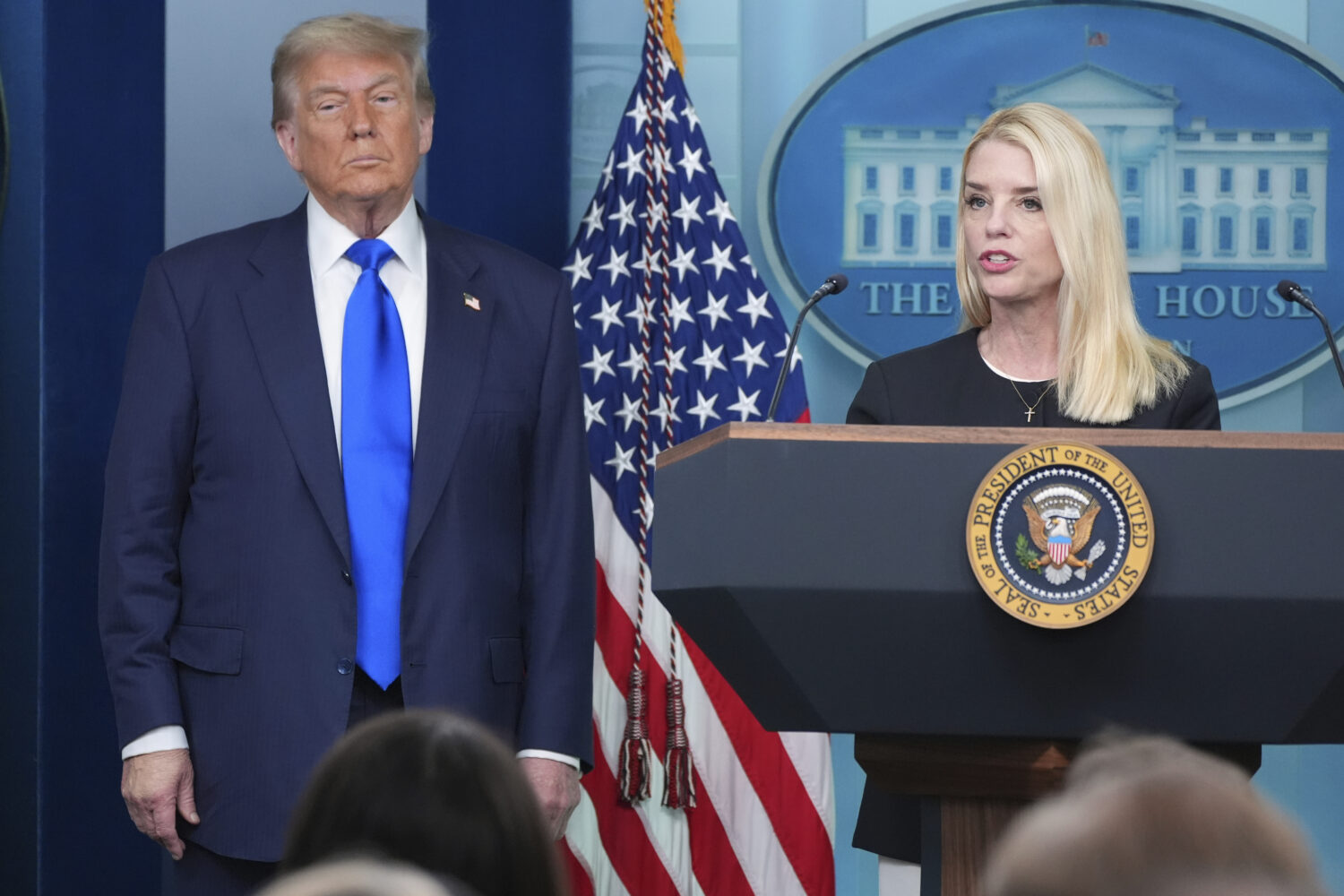 Attorney General Pam Bondi speaks to reporters as President Donald Trump listens, Friday, June 27, ...