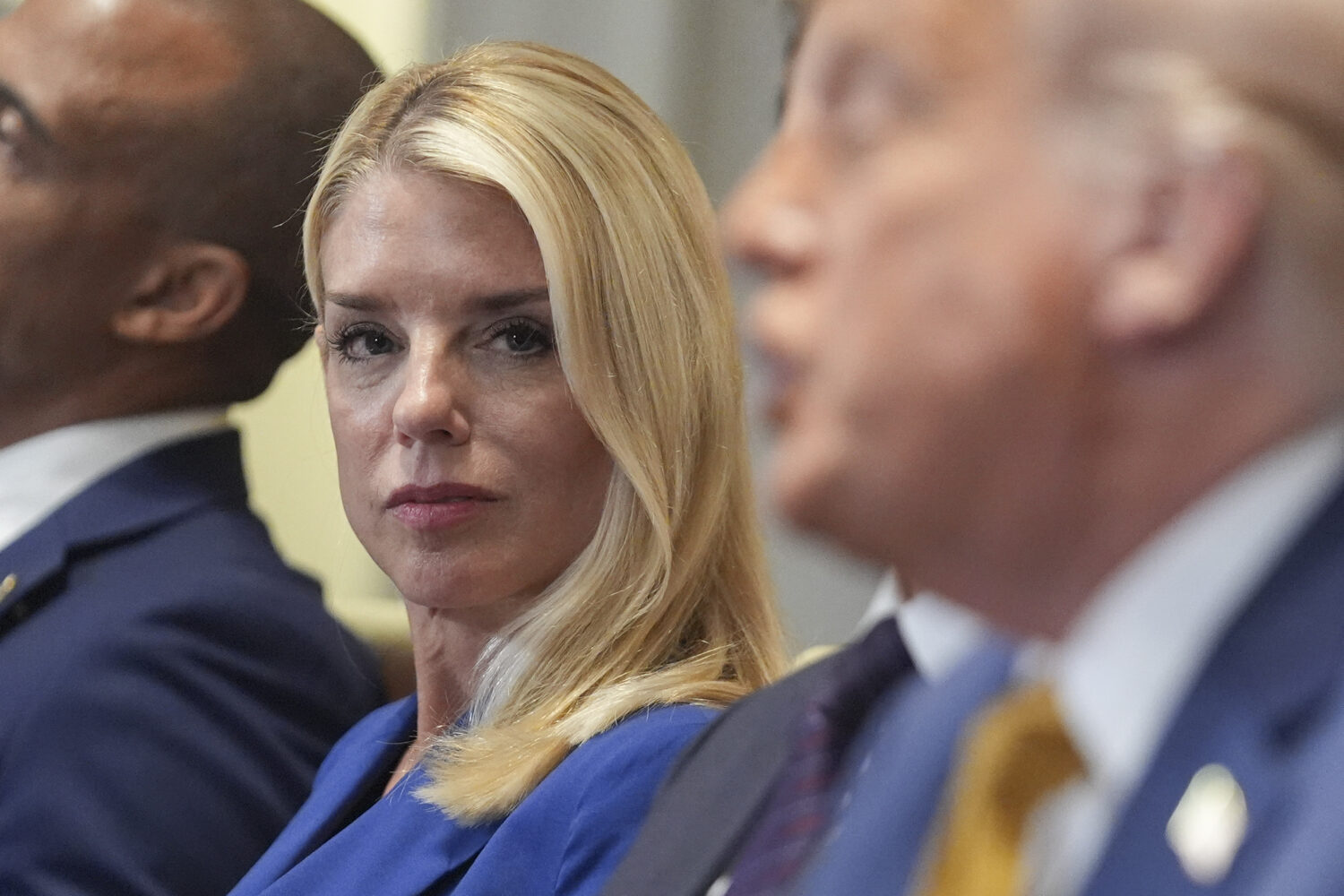 Attorney General Pam Bondi, left, listens as President Donald Trump, right, speaks during a cabinet...