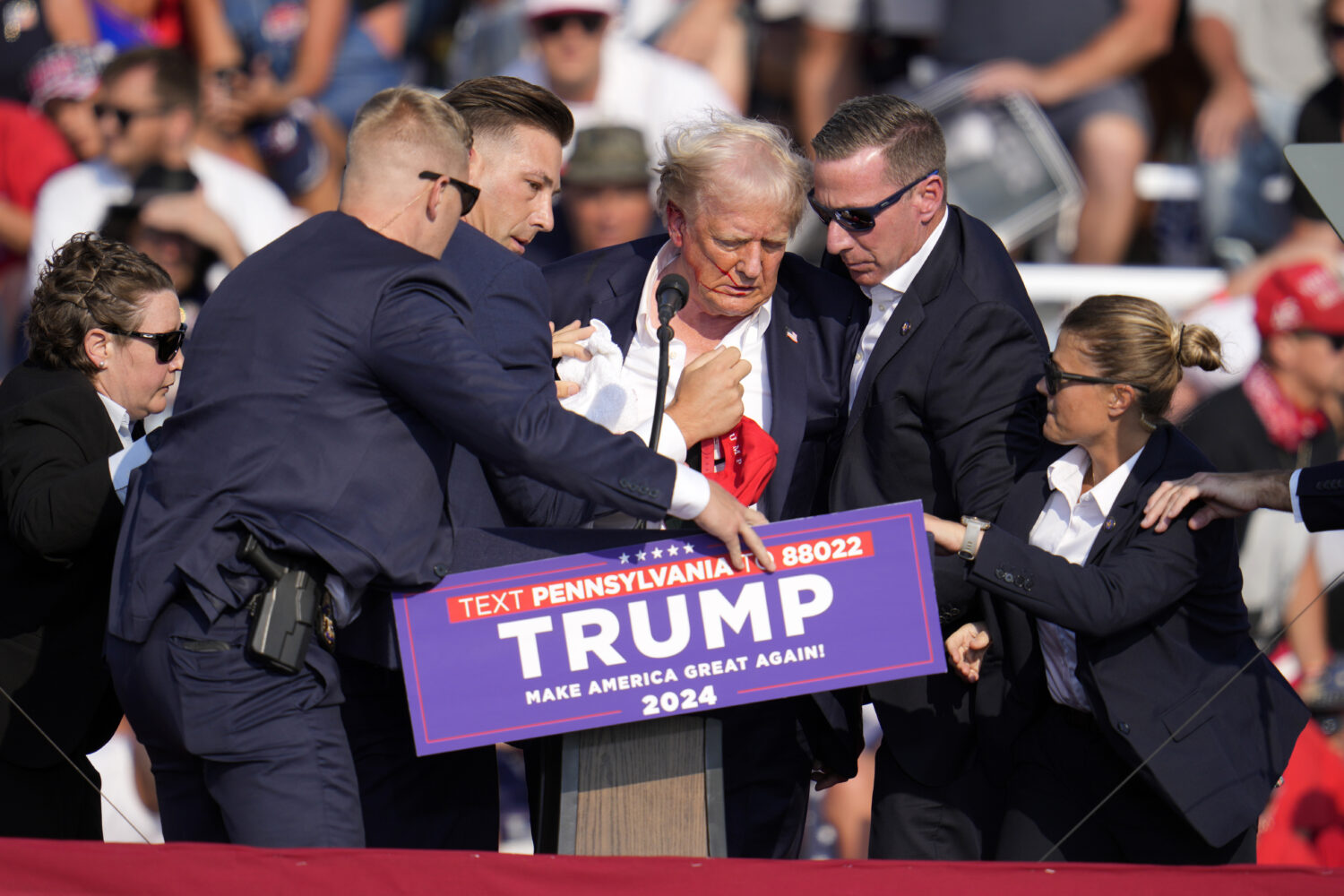 FILE - Republican presidential candidate former President Donald Trump is helped off the stage at a...