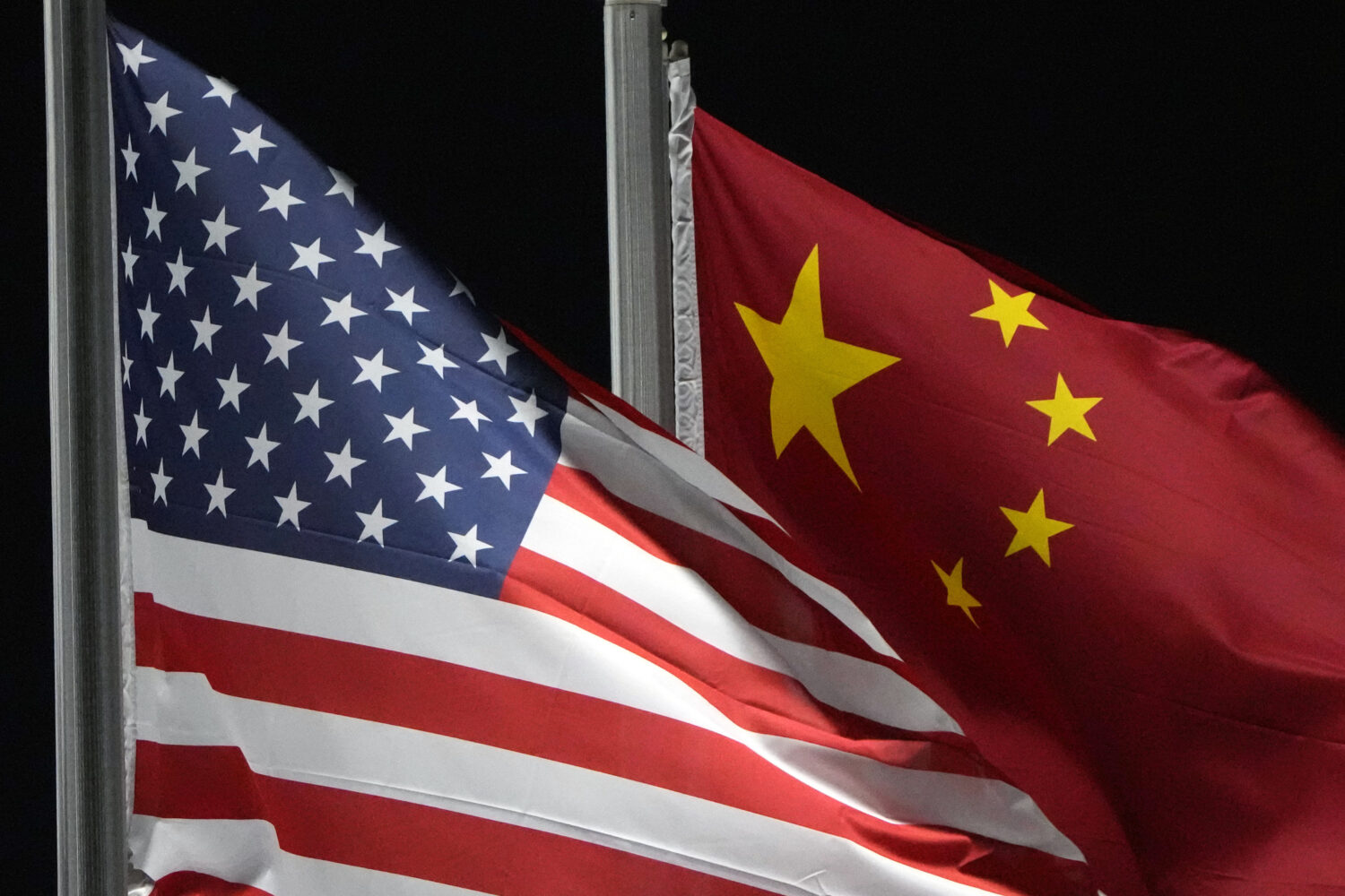 FILE - The American and Chinese flags wave, Feb. 2, 2022, in Zhangjiakou, China. (AP Photo/Kiichiro...