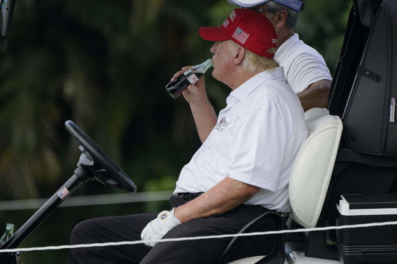 FILE - Former President Donald Trump drinks a Diet Coke during the ProAm of the LIV Golf Team Champ...