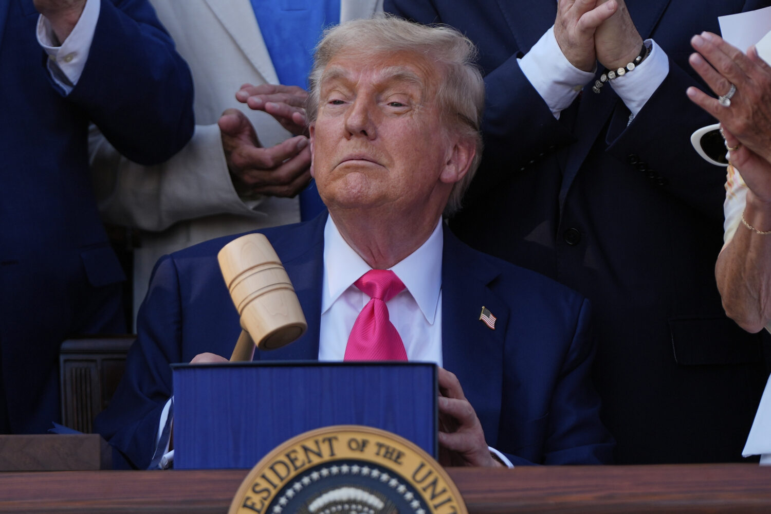 President Donald Trump holds a gavel after he signed his signature bill of tax breaks and spending ...