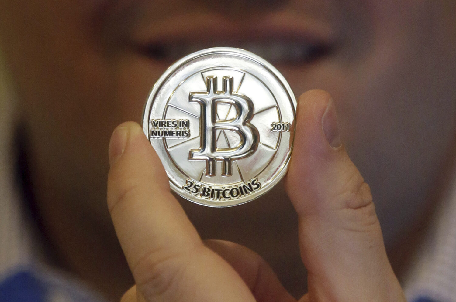 FILE - In this April 3, 2013 photo, a 25 Bitcoin token is displayed in Sandy, Utah. (AP Photo/Rick ...