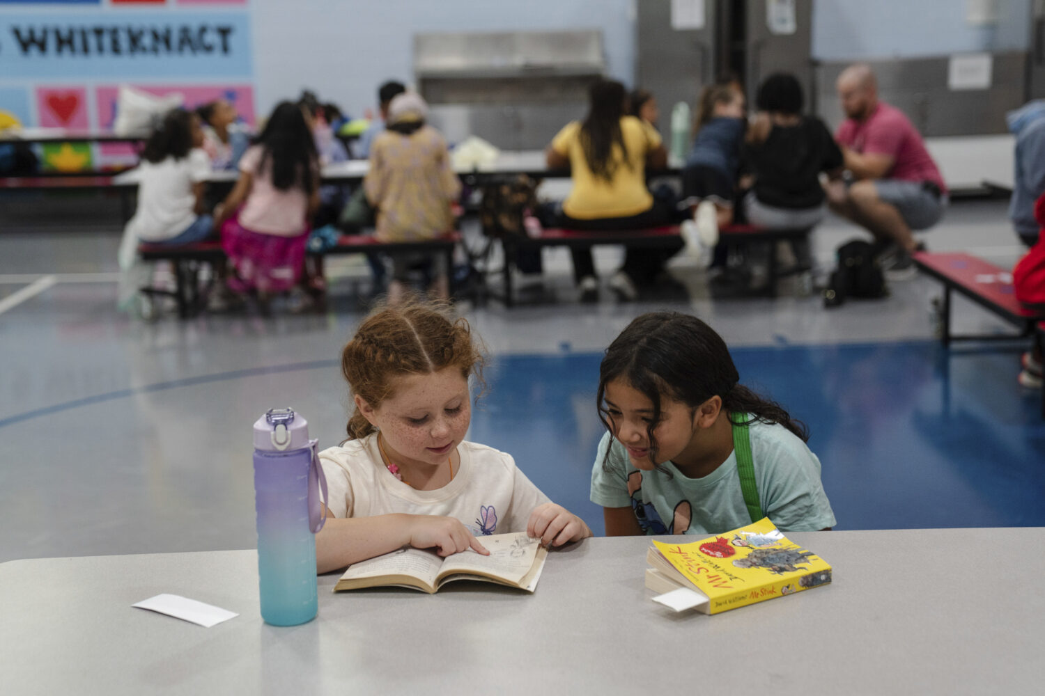 Girls read an Amelia Bedelia book during the East Providence Boys and Girls Club Summer Camp at Emm...