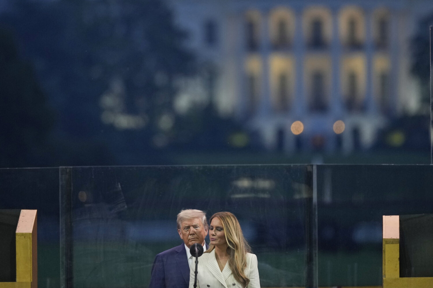 President Donald Trump and first lady Melania Trump pauses on stage during a military parade commem...