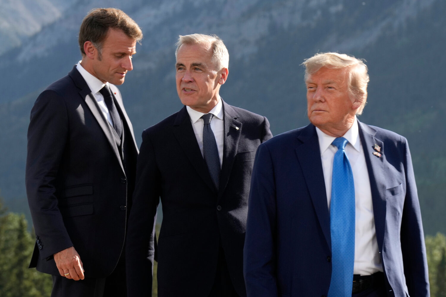 FILE - From left, French President Emmanuel Macron, Canadian Prime Minister Mark Carney and Preside...