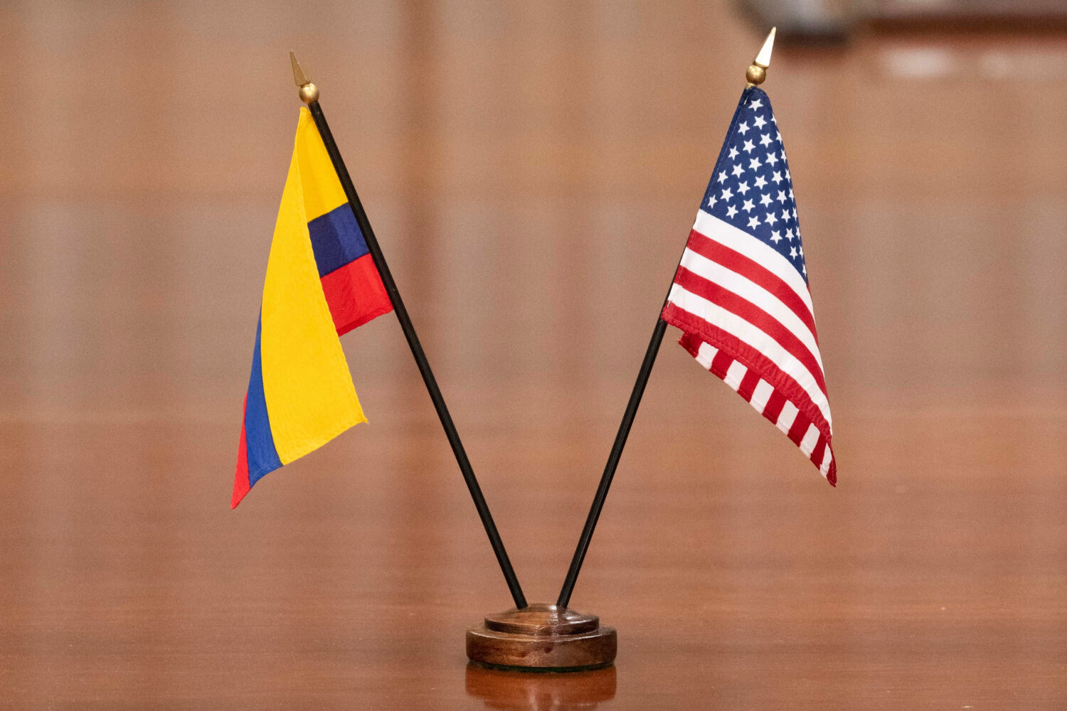 FILE - The Colombian and U.S. flags decorate the table as U.S. Secretary of Defense Lloyd Austin me...
