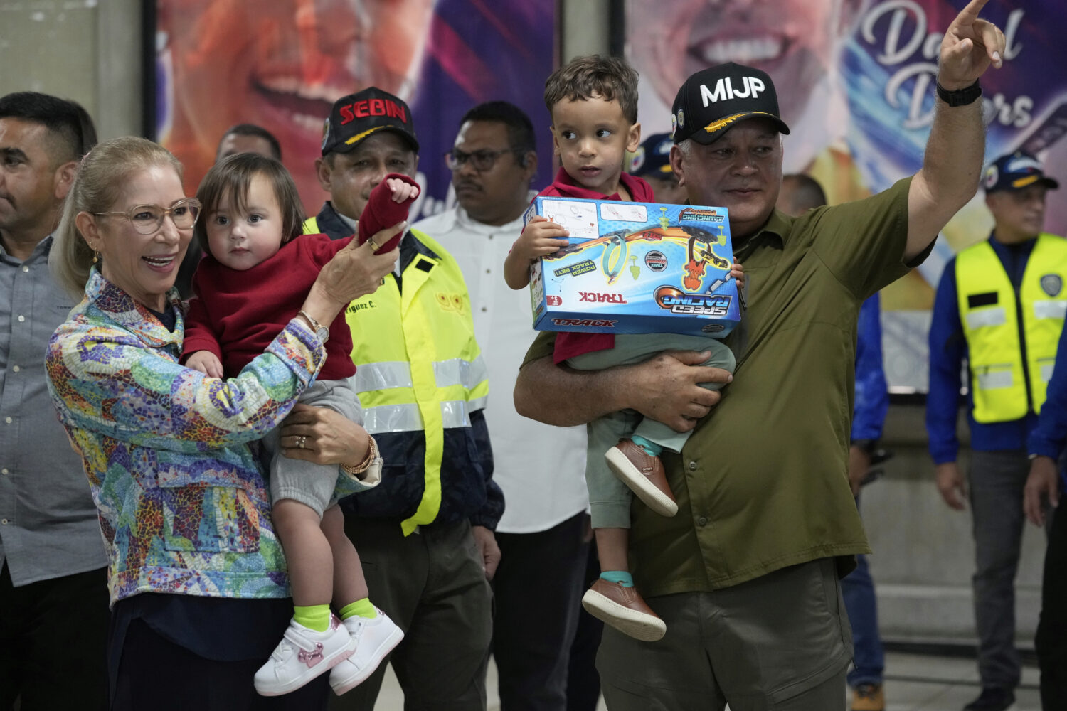Venezuela's Interior Minister Diosdado Cabello, right, and First Lady Cilia Flores welcome children...