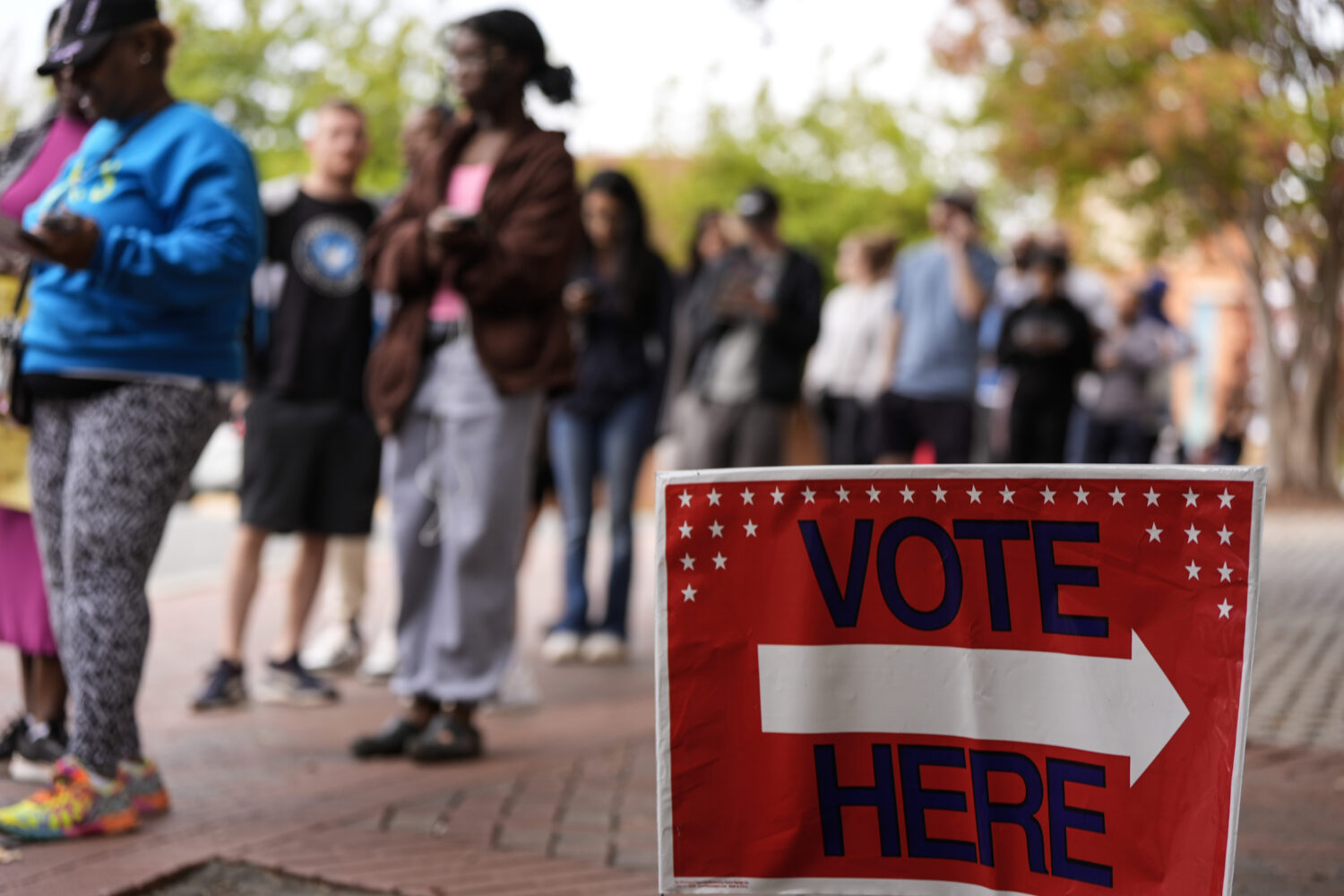 FILE - People stand in line during the last day of early voting, Saturday, Nov. 2, 2024, in Charlot...
