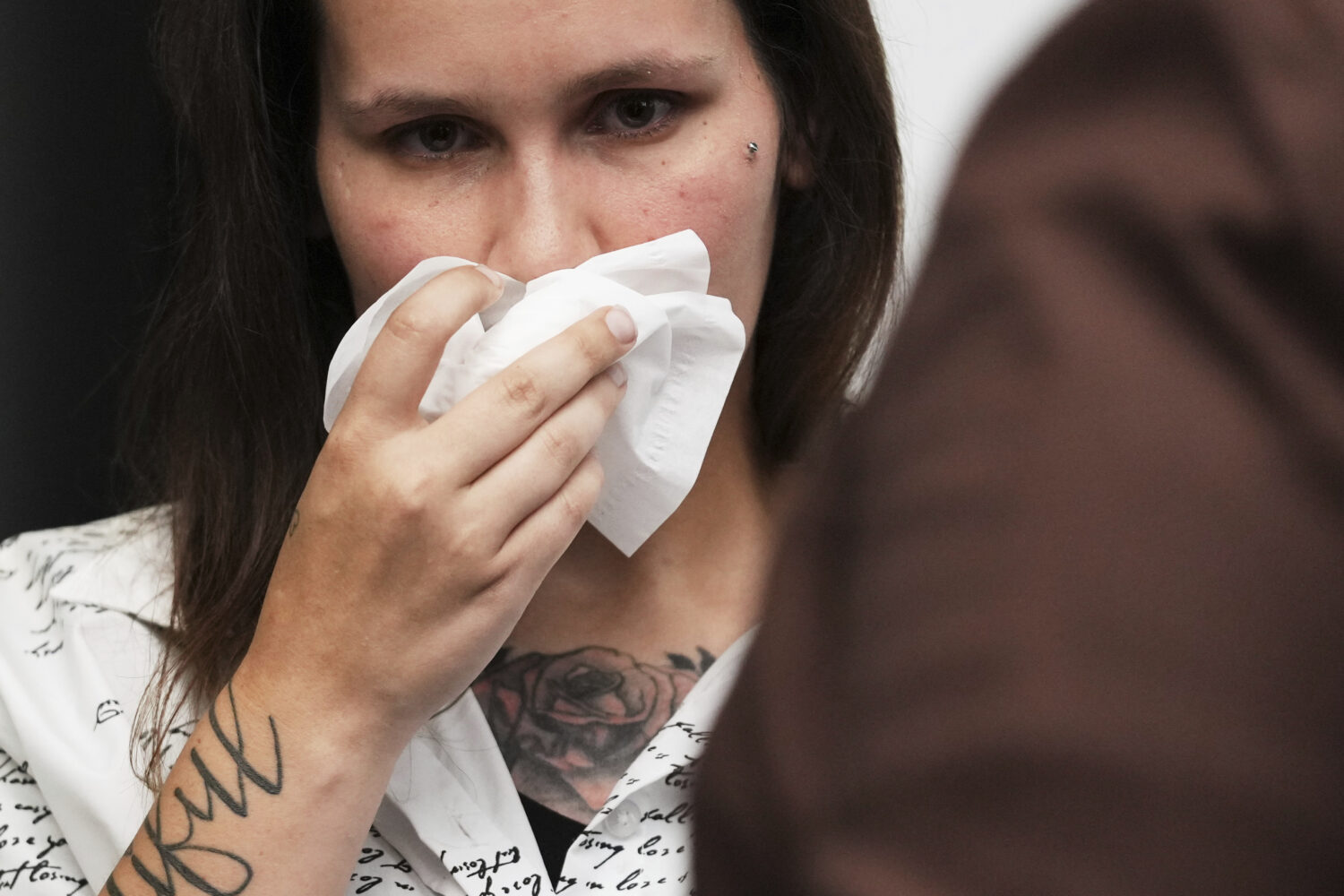 One of sexual assault survivor Kate-Lynn (first name only), wipes his face after talking to media d...