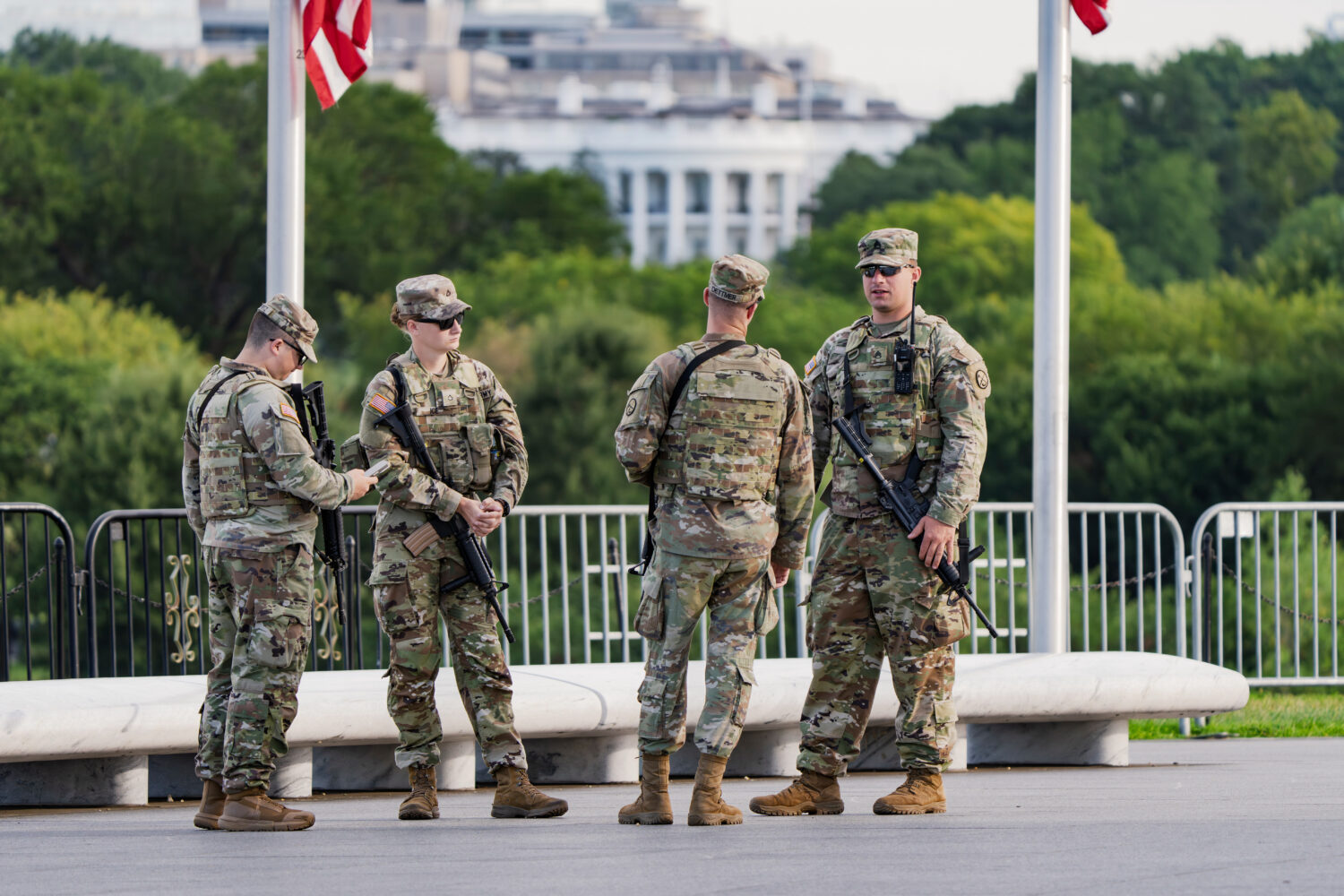 With the White House in the distance, National Guard troops patrol the Mall as part of President Do...
